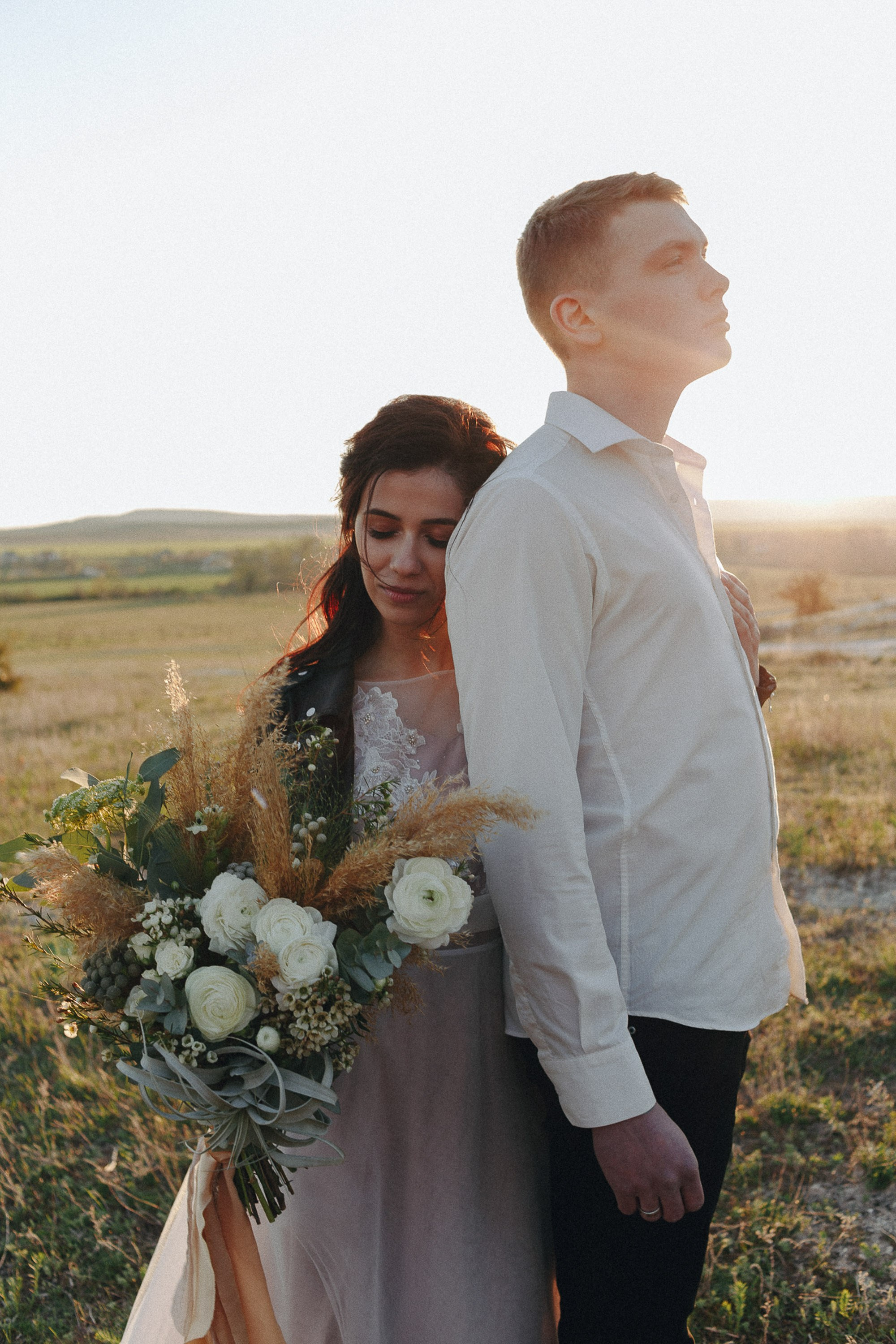 Bride and groom smiling in nature, outdoor wedding portrait