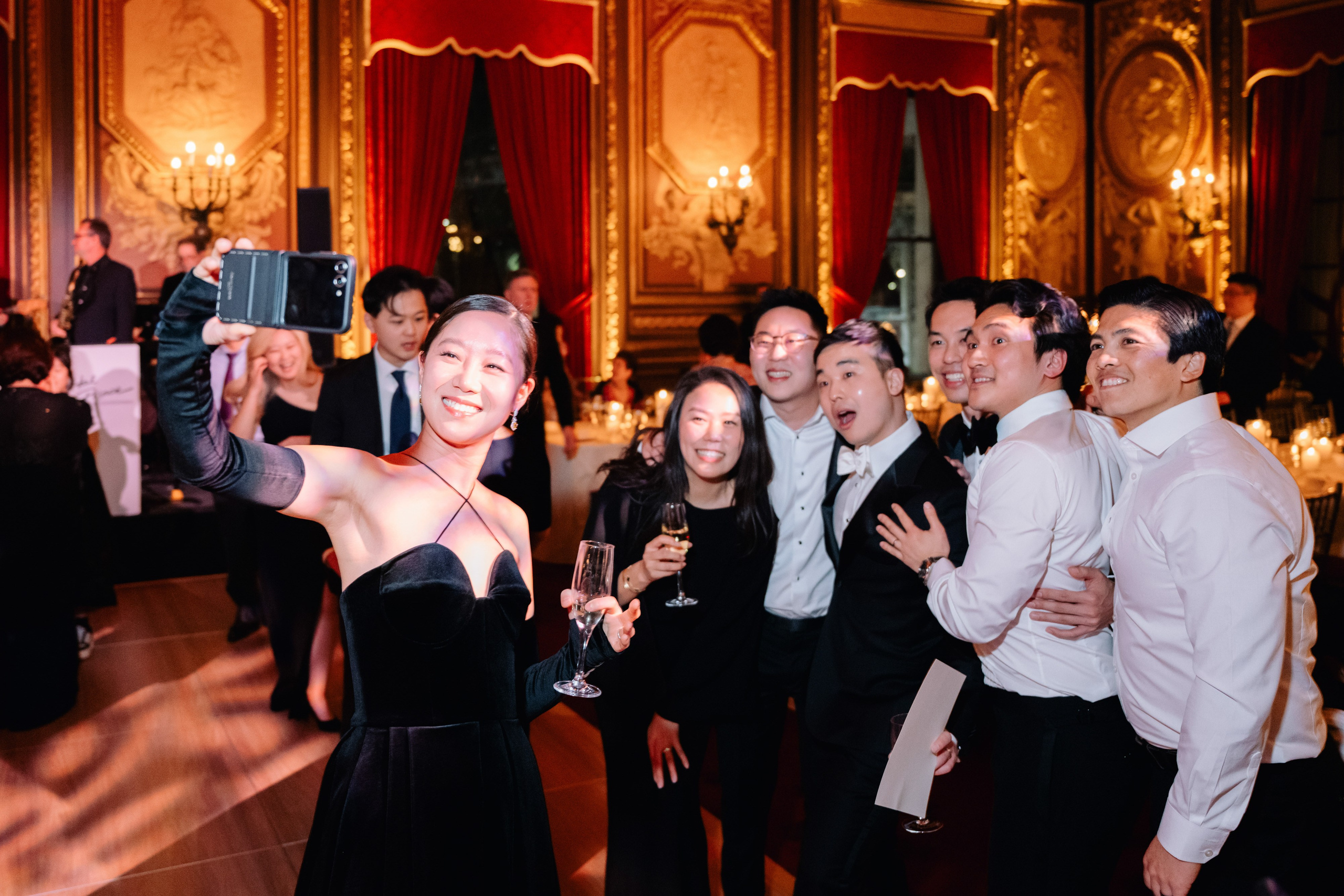 a group of people standing around a table