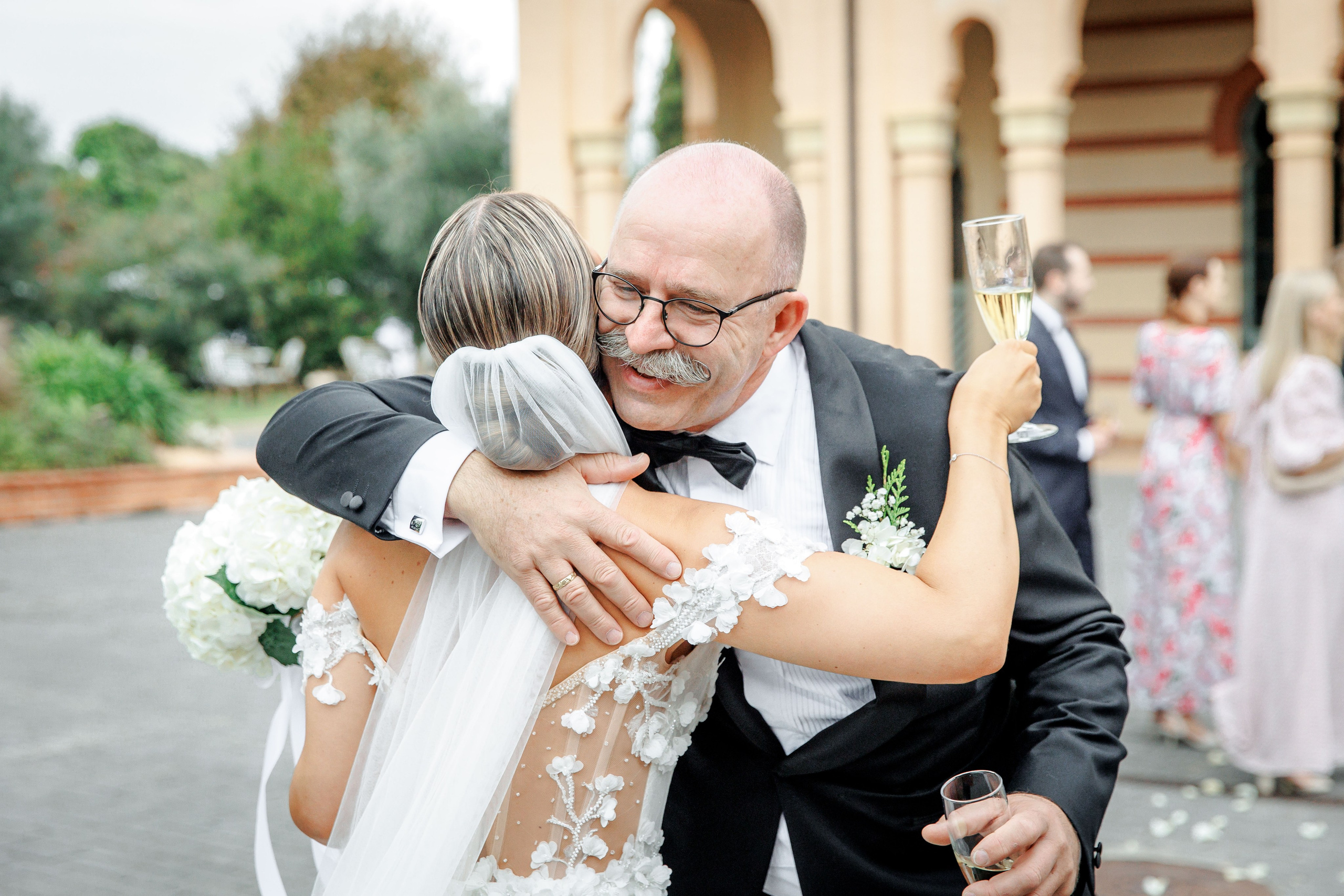 Bride sharing a joyful moment with her father after the wedding ceremony in Barcelona.
