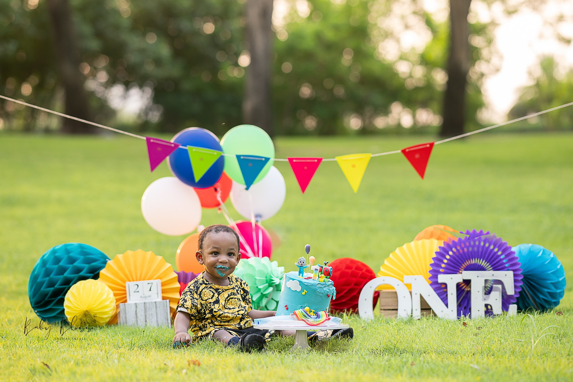 outdoor rainbow, colourful theme with banner and helium balloons in the background in Doha