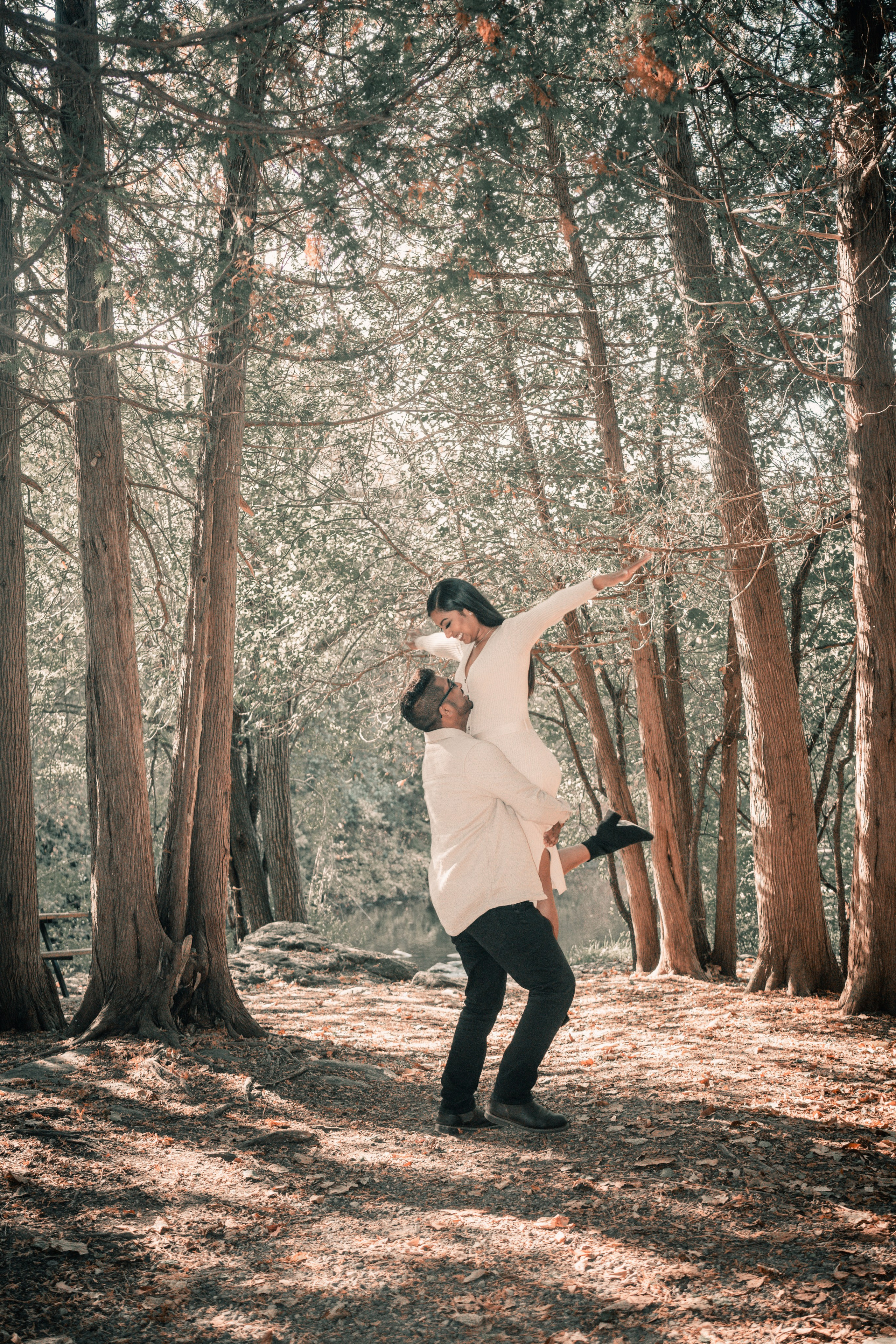 Couple walking through a golden autumn park, capturing their engagement moments