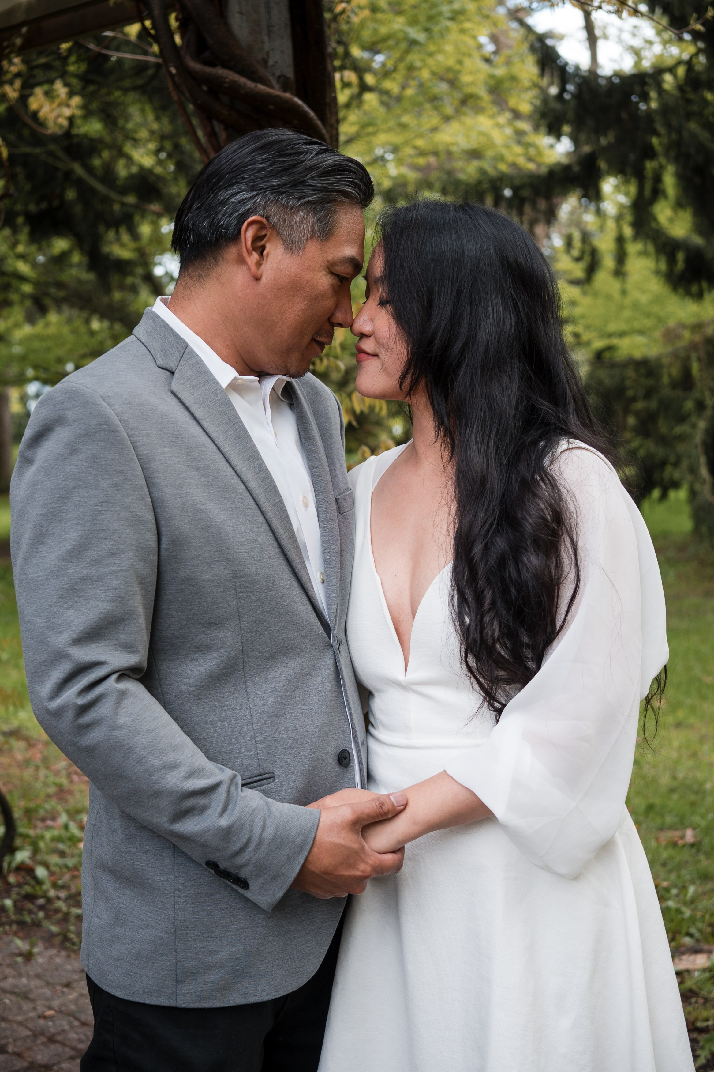 Engaged couple hugging in a forest during a romantic photoshoot