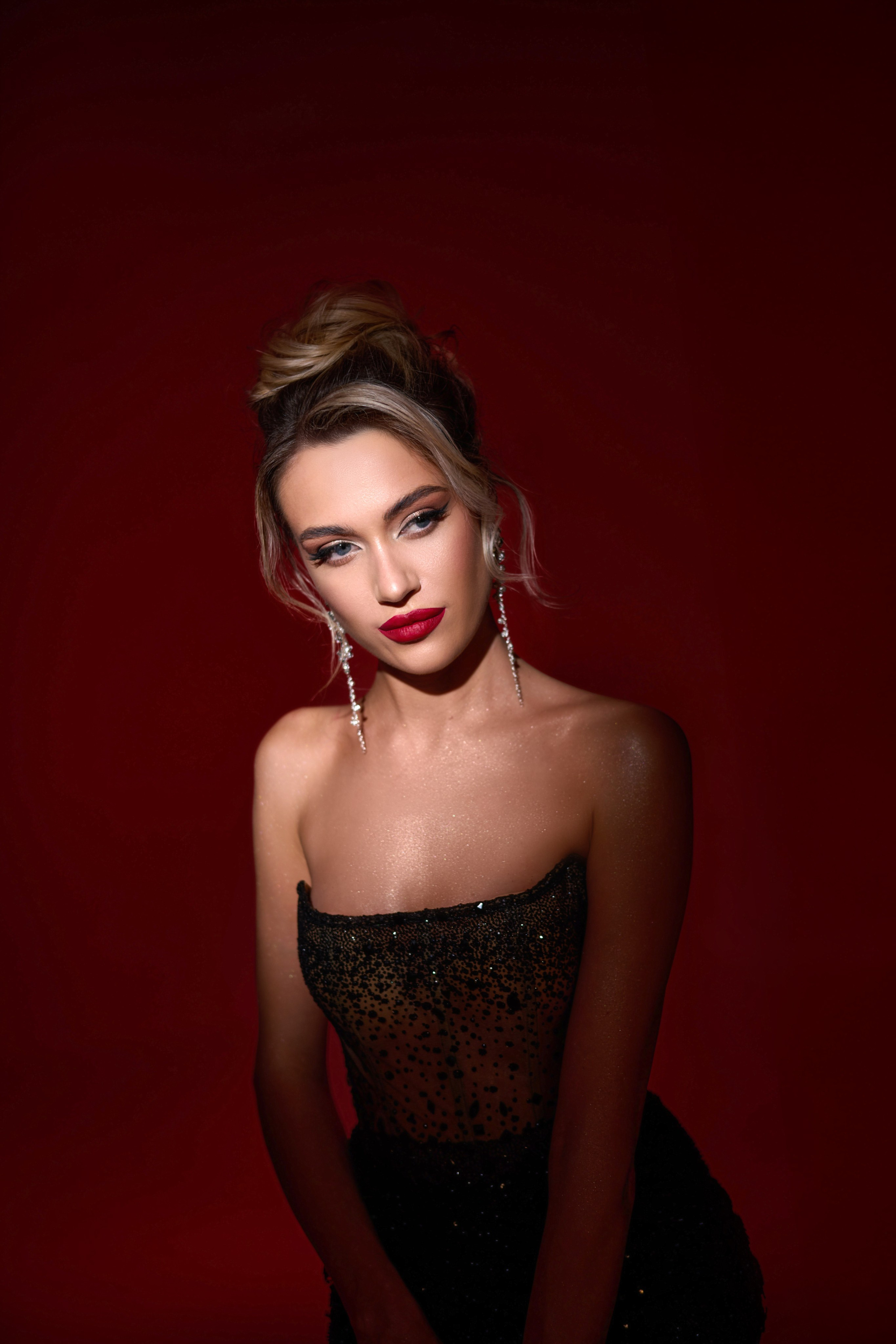 Artistic red light close-up fashion portrait of model in couture gown Warsaw studio