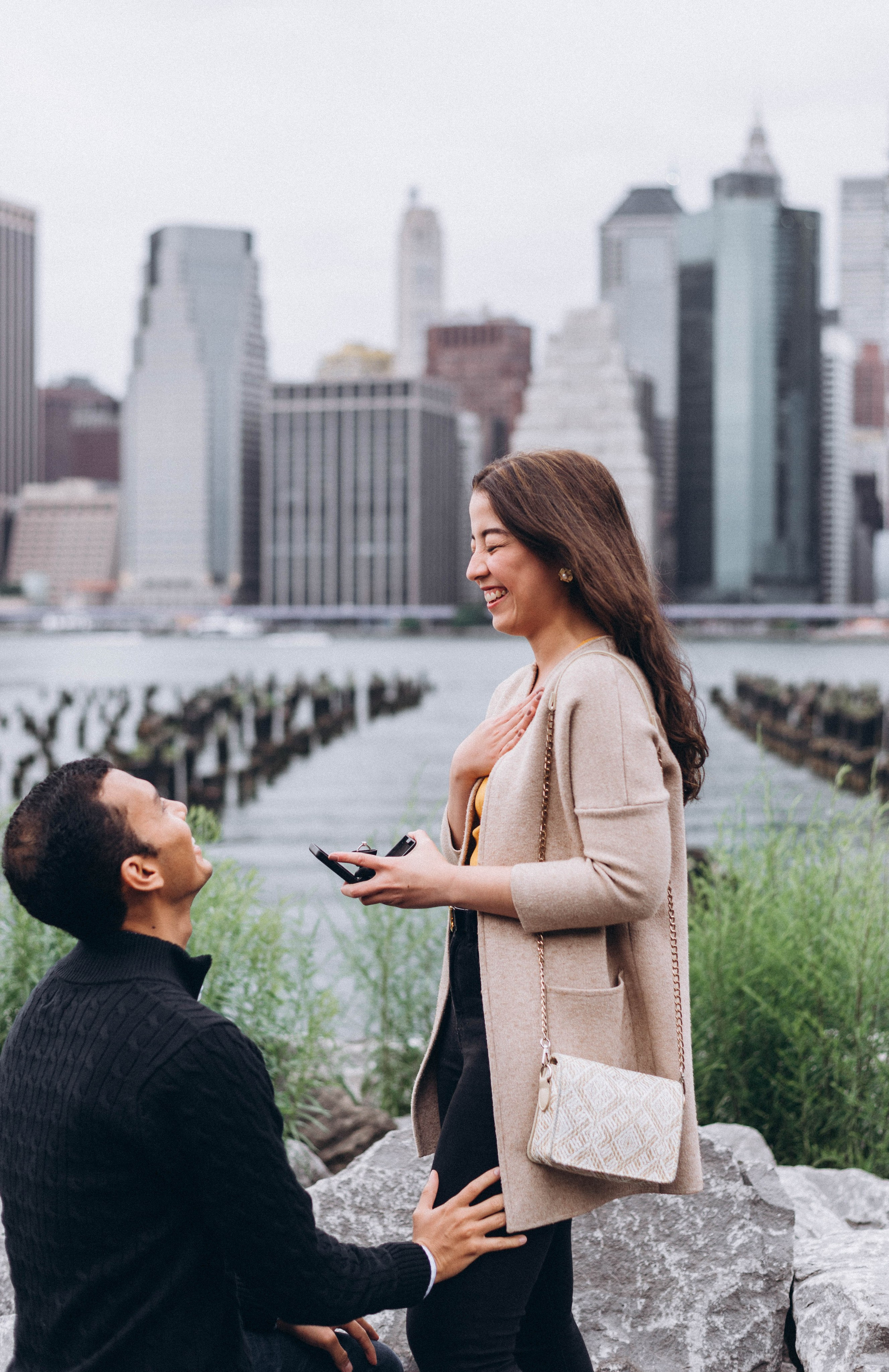 Emotional bride-to-be covering face in Central Park.
