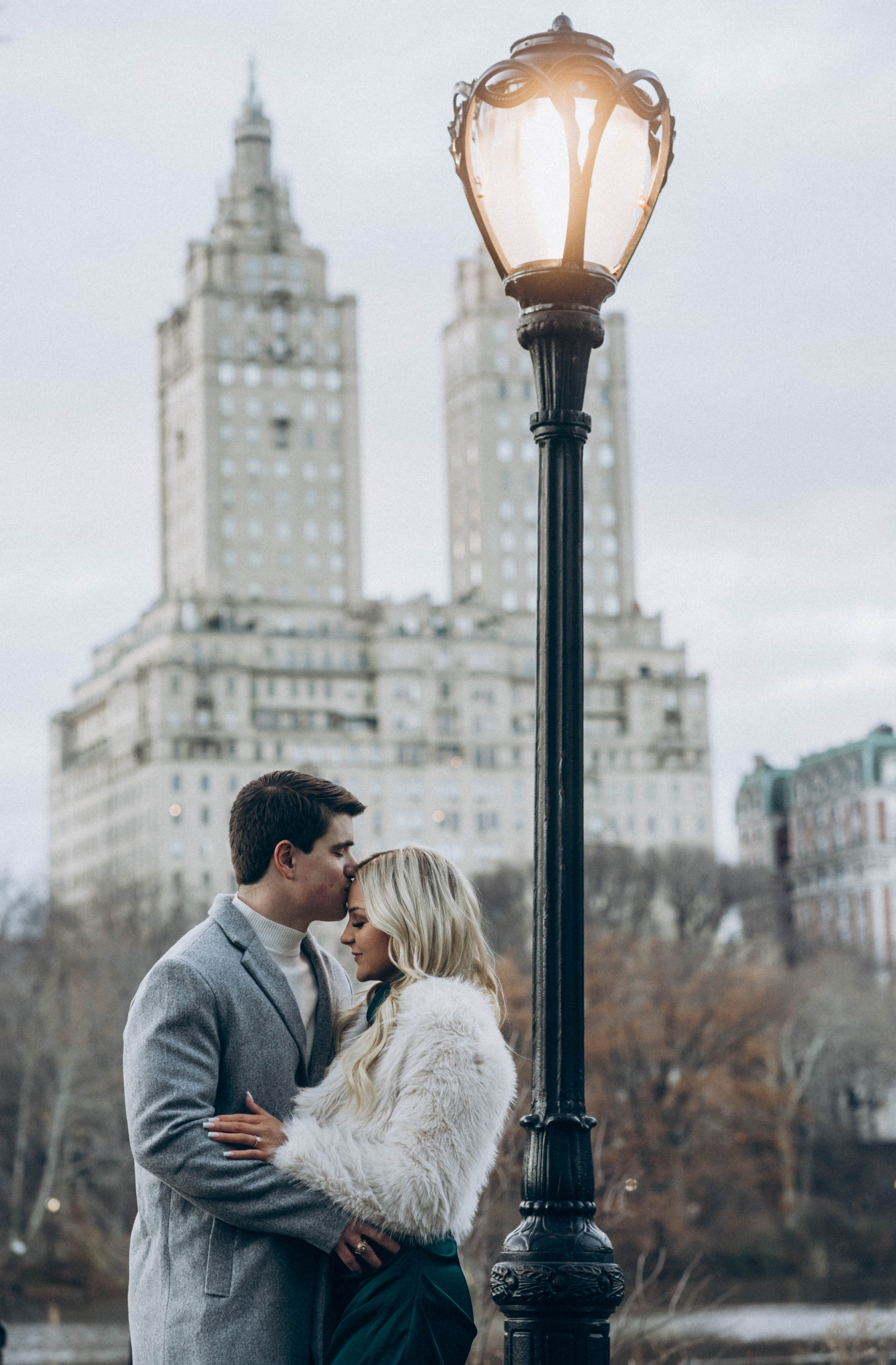 Surprise engagement in Dumbo with cobblestone backdrop.