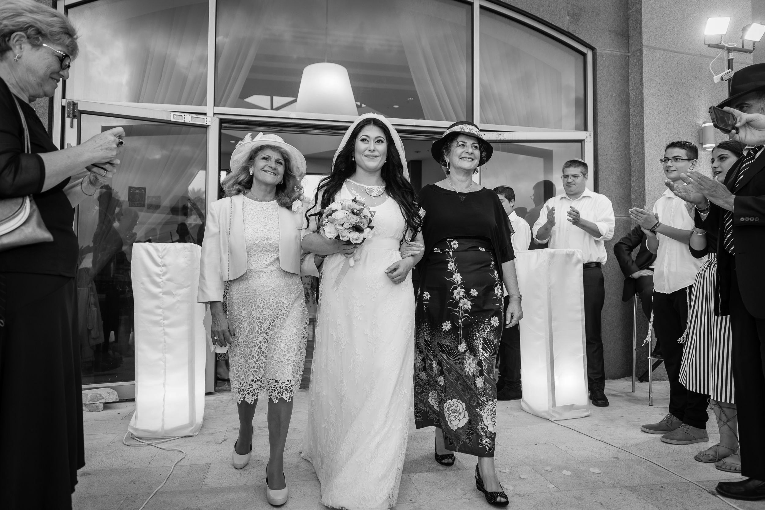 Simone walking to the Chuppah with her mothers during the wedding ceremony at the Leonardo Hotel in Haifa, Israel