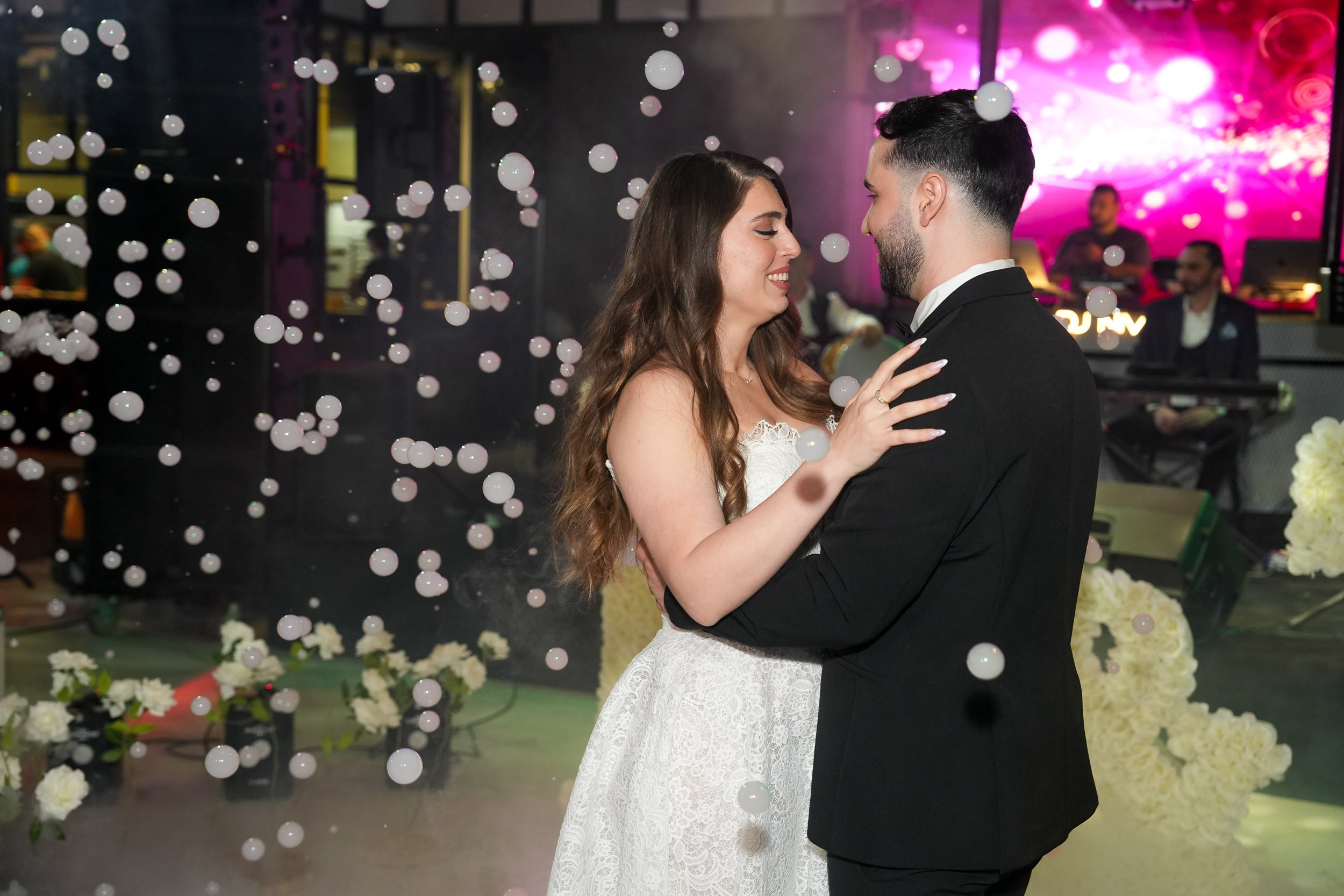Bride Tzipi and groom Ron sharing their romantic first dance surrounded by bubbles at 88 Event Garden in Emek Hefer, Israel