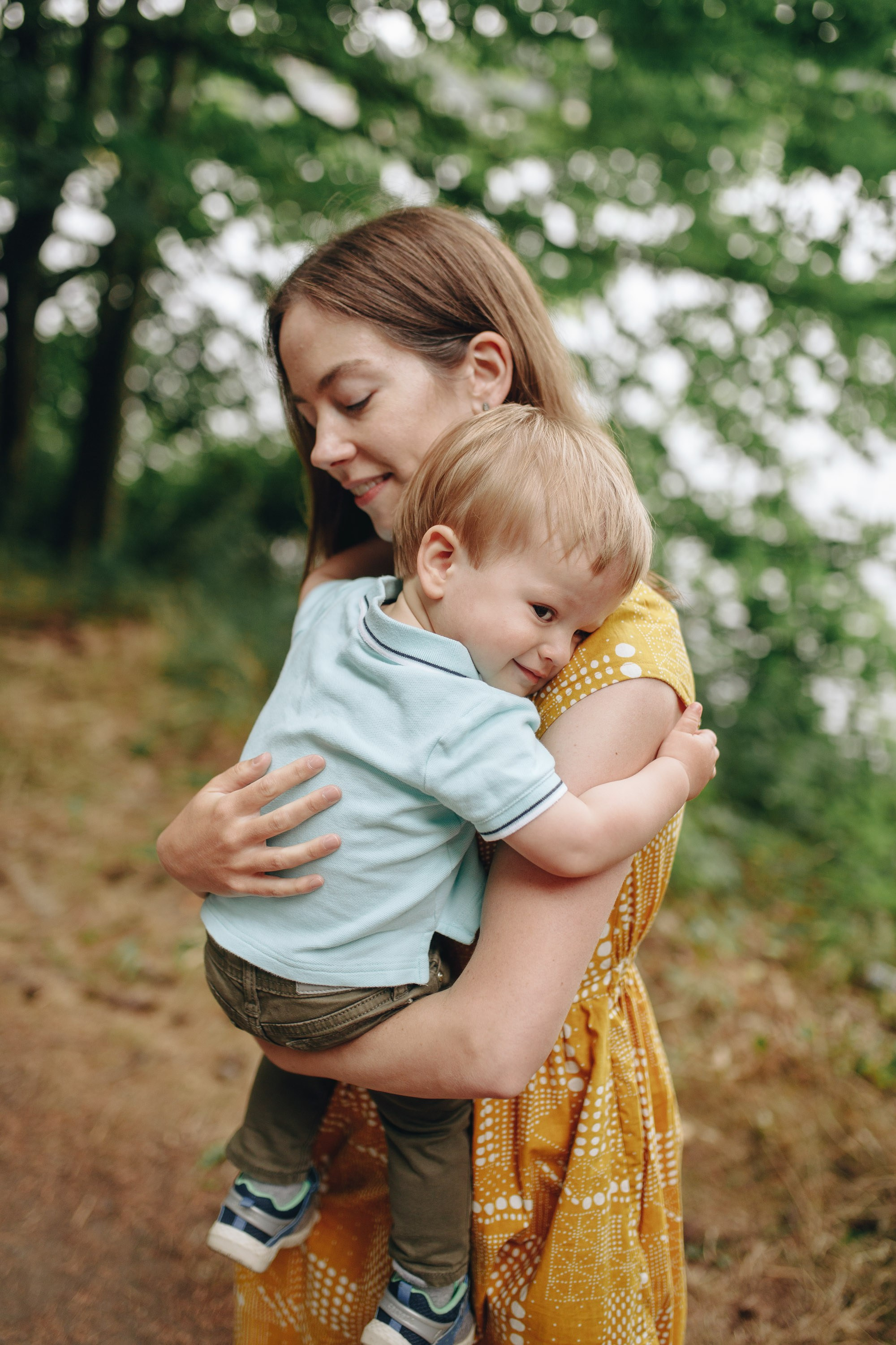 Mother holding baby outdoors, family portrait