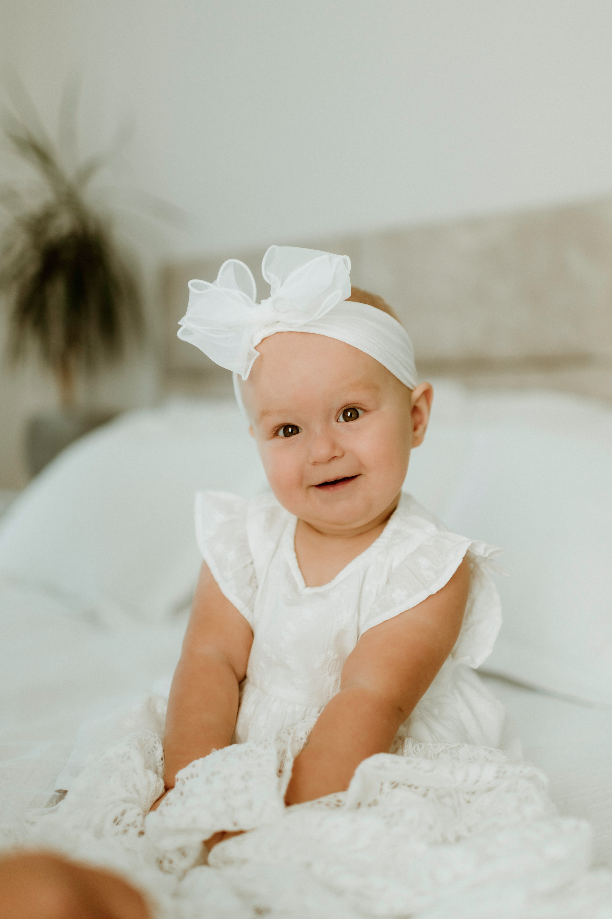 An enchanting outdoor maternity photoshoot at the client's house. The image features a radiant mother and her daughter, both elegantly dressed in white, against the backdrop of their home. The simplicity of their attire and the natural surroundings creates a timeless and intimate atmosphere. Book a personalized outdoor session with MD Studio to capture beautiful moments in the comfort of your own home