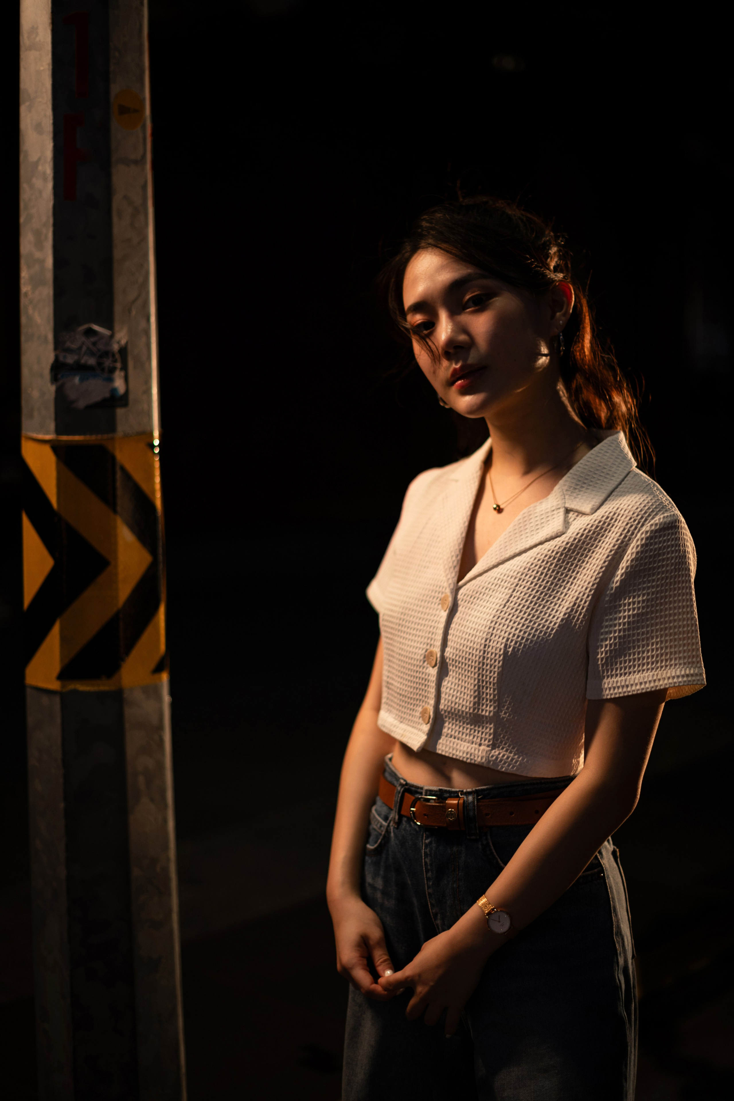 Bold Singapore street photography at night with a striking street light illuminating the urban scene. This editorial-style image by a freelance photographer showcases creative lighting and moody contrasts ideal for commercial and branding projects.