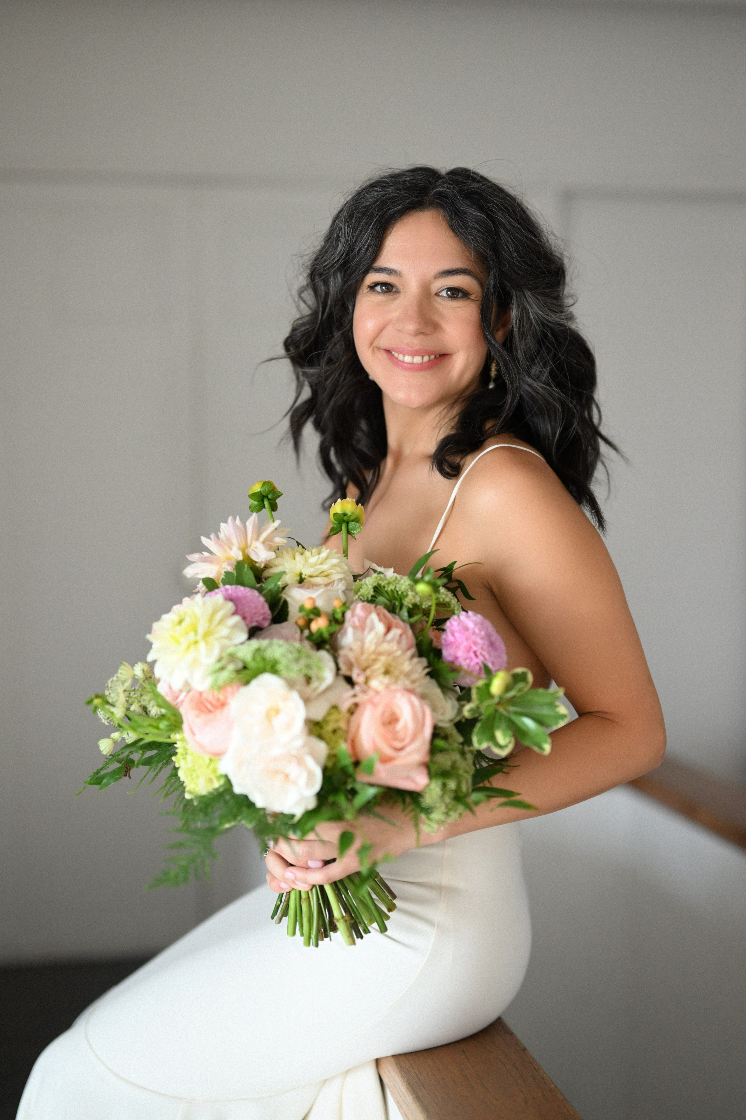 a woman in a white dress holding a bouquet
