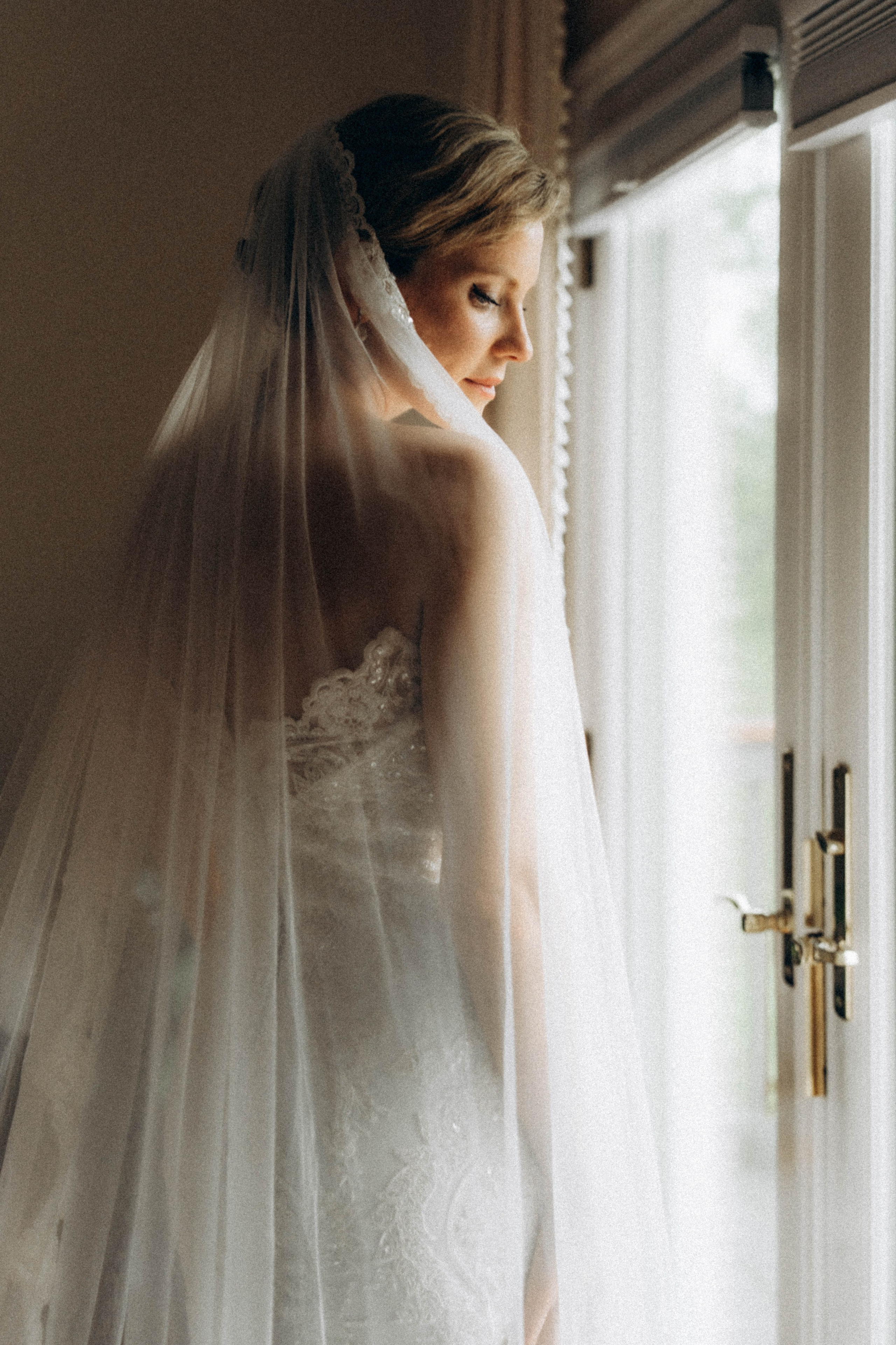 Bride adjusting dress on Schenectady church steps.