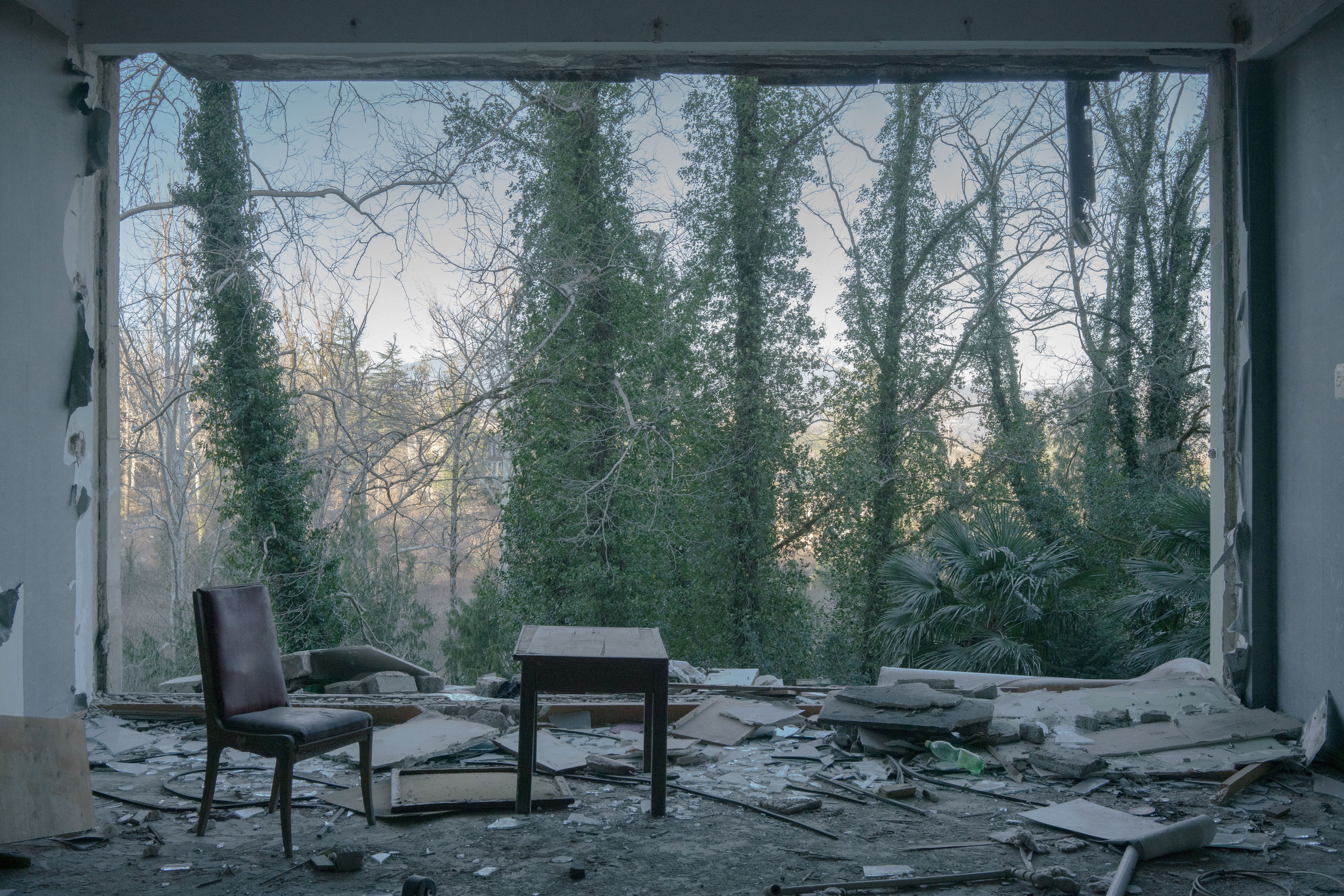 The hall of the former sanatorium «Sakartvelo». When Mikhail Saakashvili came to power in Georgia in 2004, the country’s tourism reform began - former resort towns began to be rebuilt or reconstructed. Sakartvelo Sanatorium, one of the largest in Tskaltubo, where about 1,000 refugees lived, was resettled and bought by a private person. Everything that the refugees did not take with them is thrown out of the windows of the sanatorium to clear the space and prepare the building for restoration.