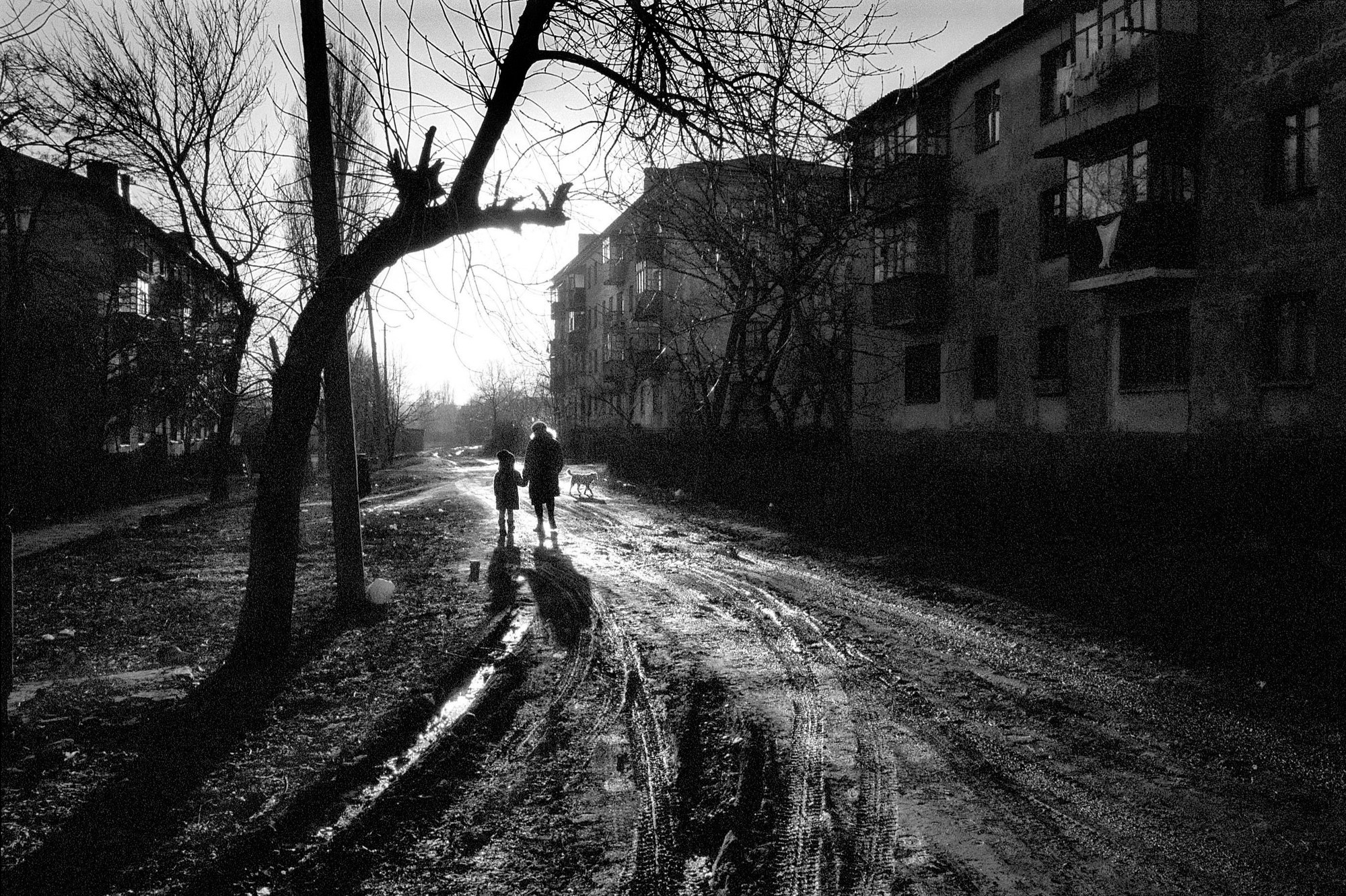 A mother and child walk along a main street February, 25, 2002 in Snezhnoye, Ukraine. Many mining families feel that the government in Kiev has abandoned them leaving them with no alternative but the dangerous, mafia controlled mines. As one miner stated, "at least it's an honest living and were not hurting anyone." 