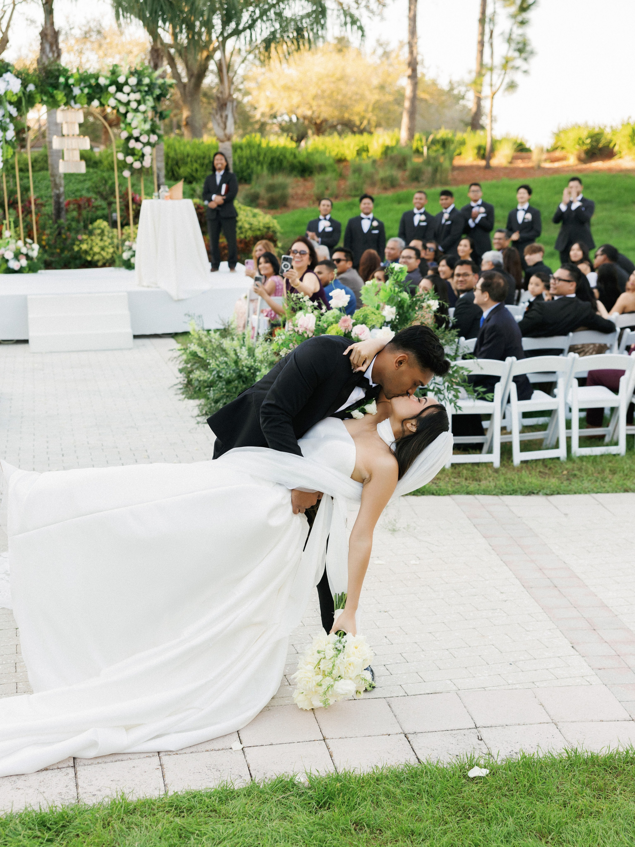 Bride walking down the aisle at an outdoor wedding ceremony