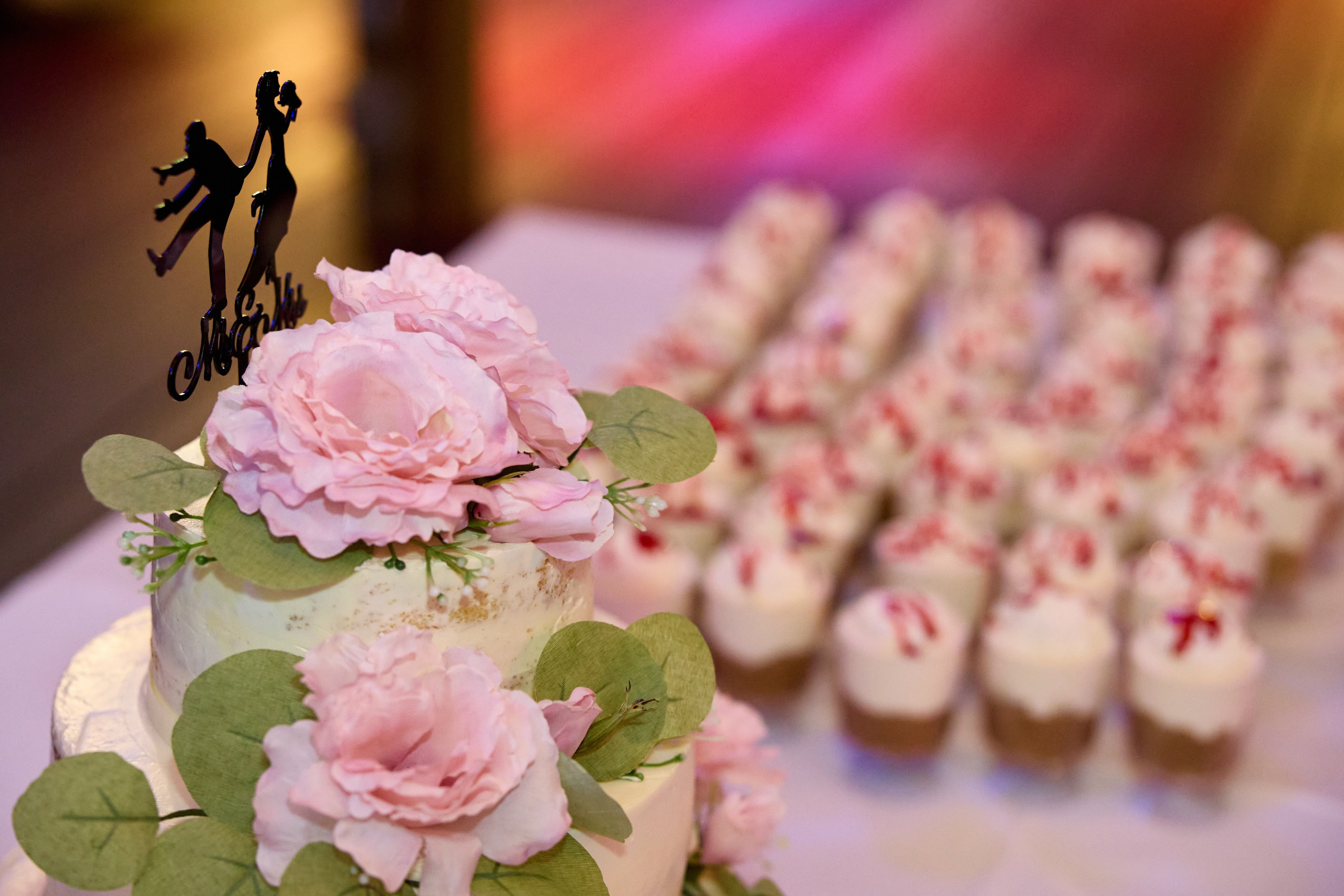 Elegant wedding cake with blush flowers and eucalyptus details
