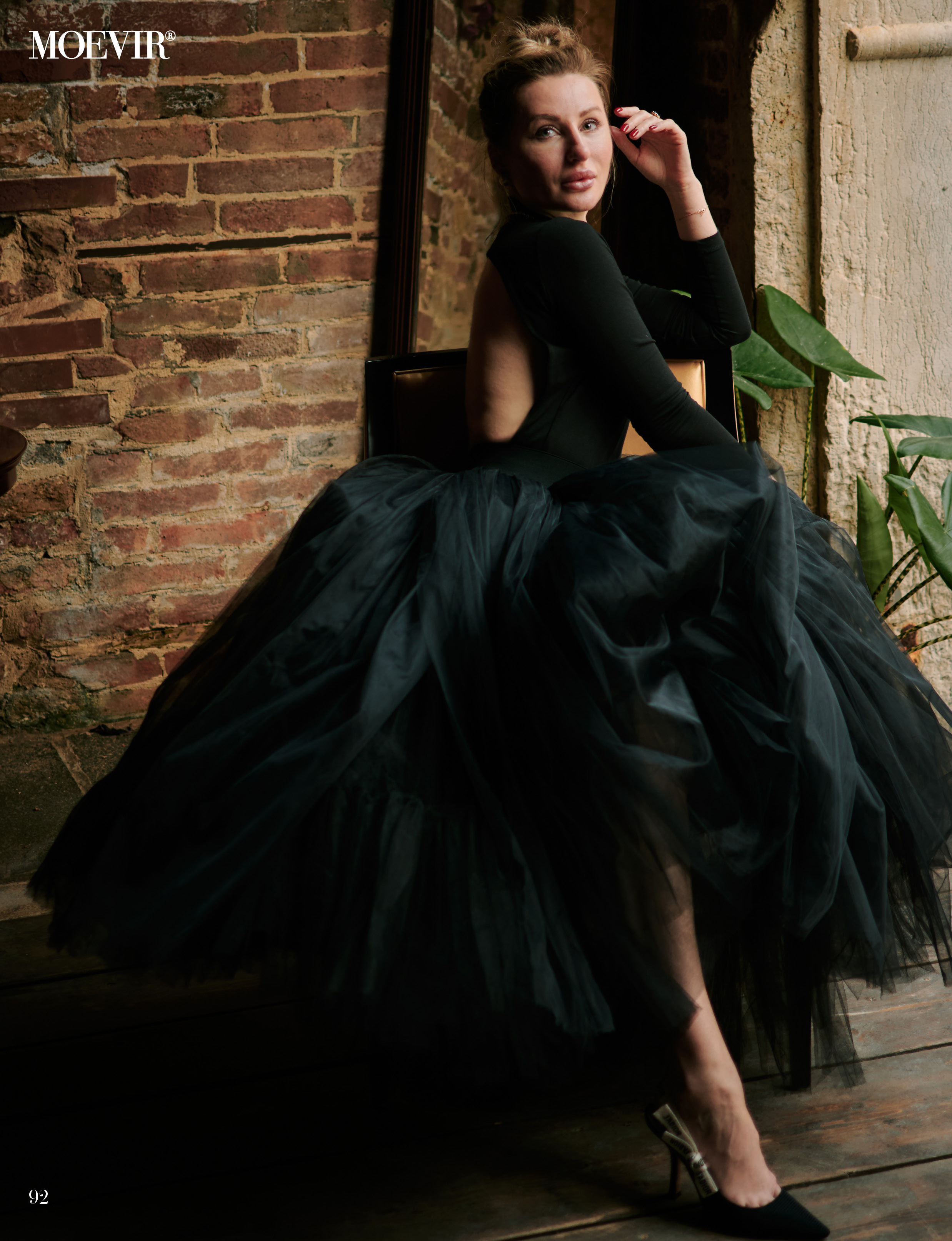 A young woman stands in the heart of San Marco Square in Venice, wearing a stunning black dress that accentuates her beauty. The panoramic view of the Laguna in the background adds to the romantic atmosphere of the scene. The ornate architecture of the surrounding buildings is a testament to the city's rich history and culture. The woman's hair flows gently in the breeze as she gazes out at the stunning view, lost in thought. The vibrant energy of the bustling square is palpable, making for a truly memorable photo shoot.