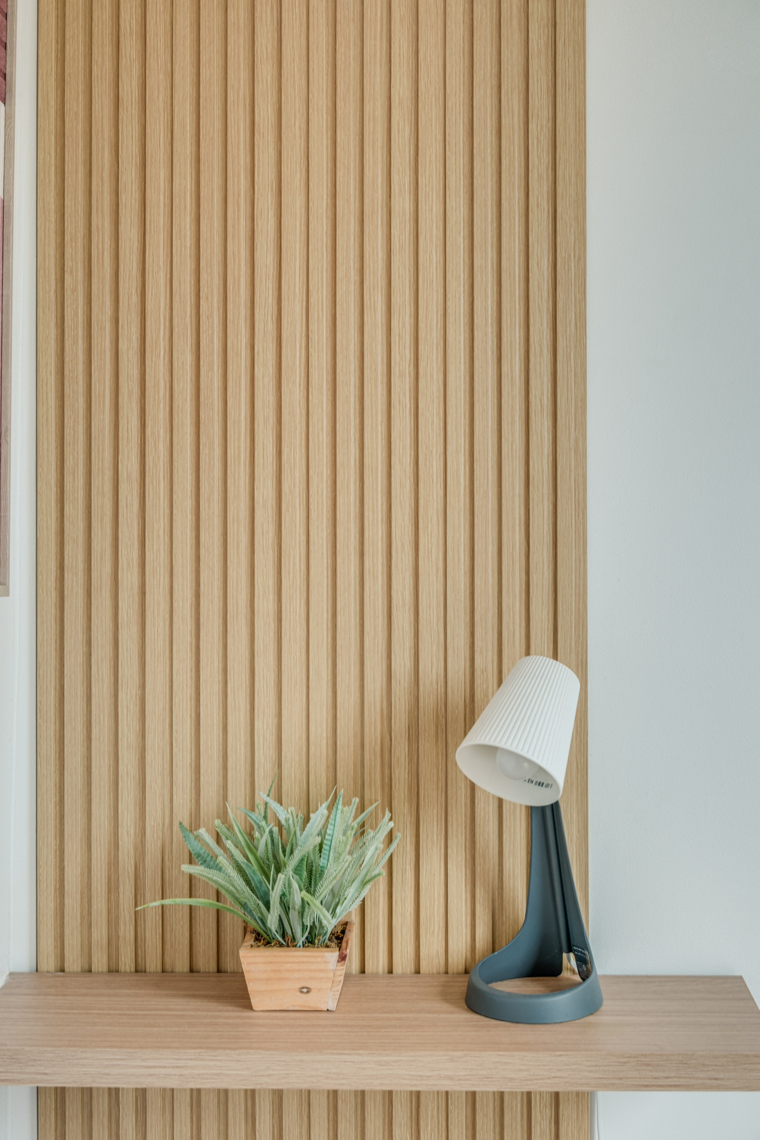 Professional interior photograph of a modern condo featuring a minimalist living room, dining area, warm wood finishes, and soft natural lighting.
