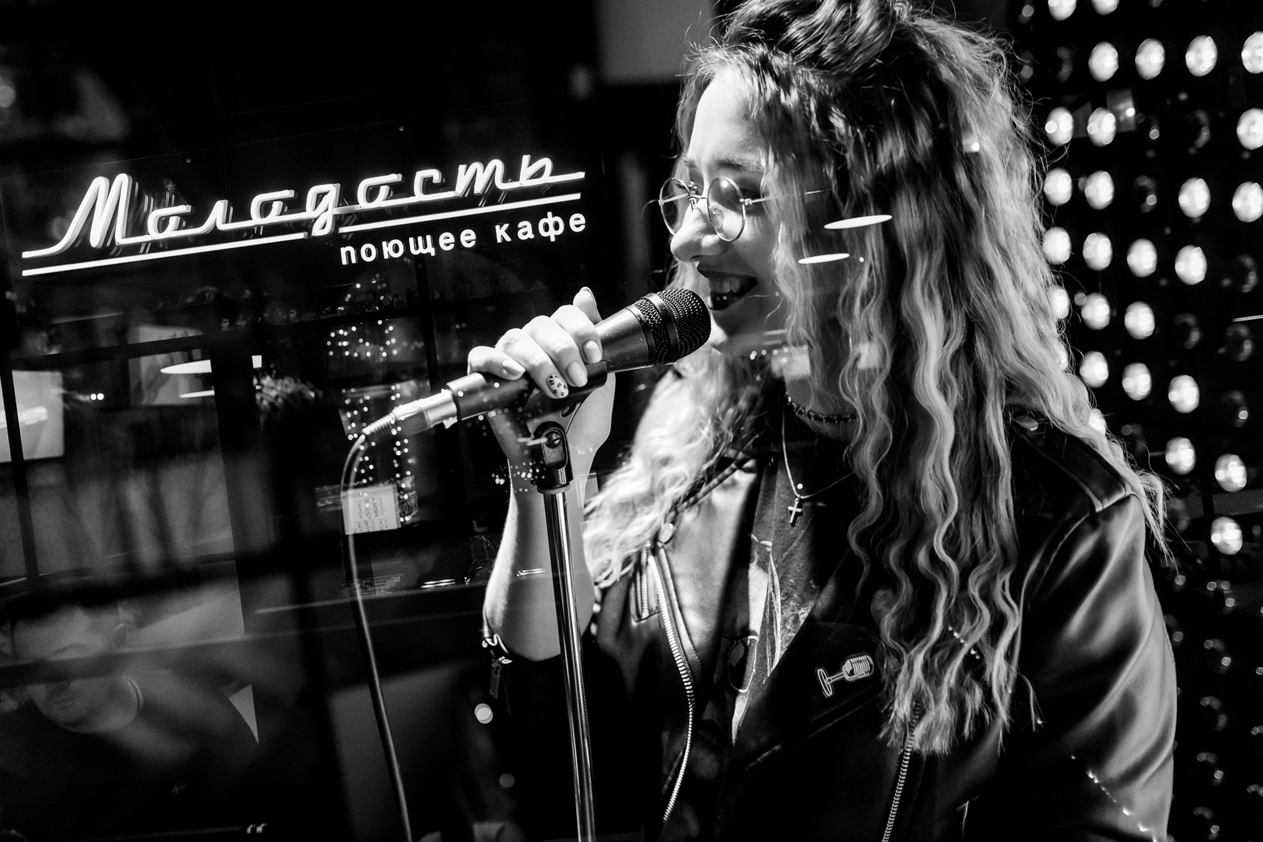 Woman singing on stage, black and white concert shot
