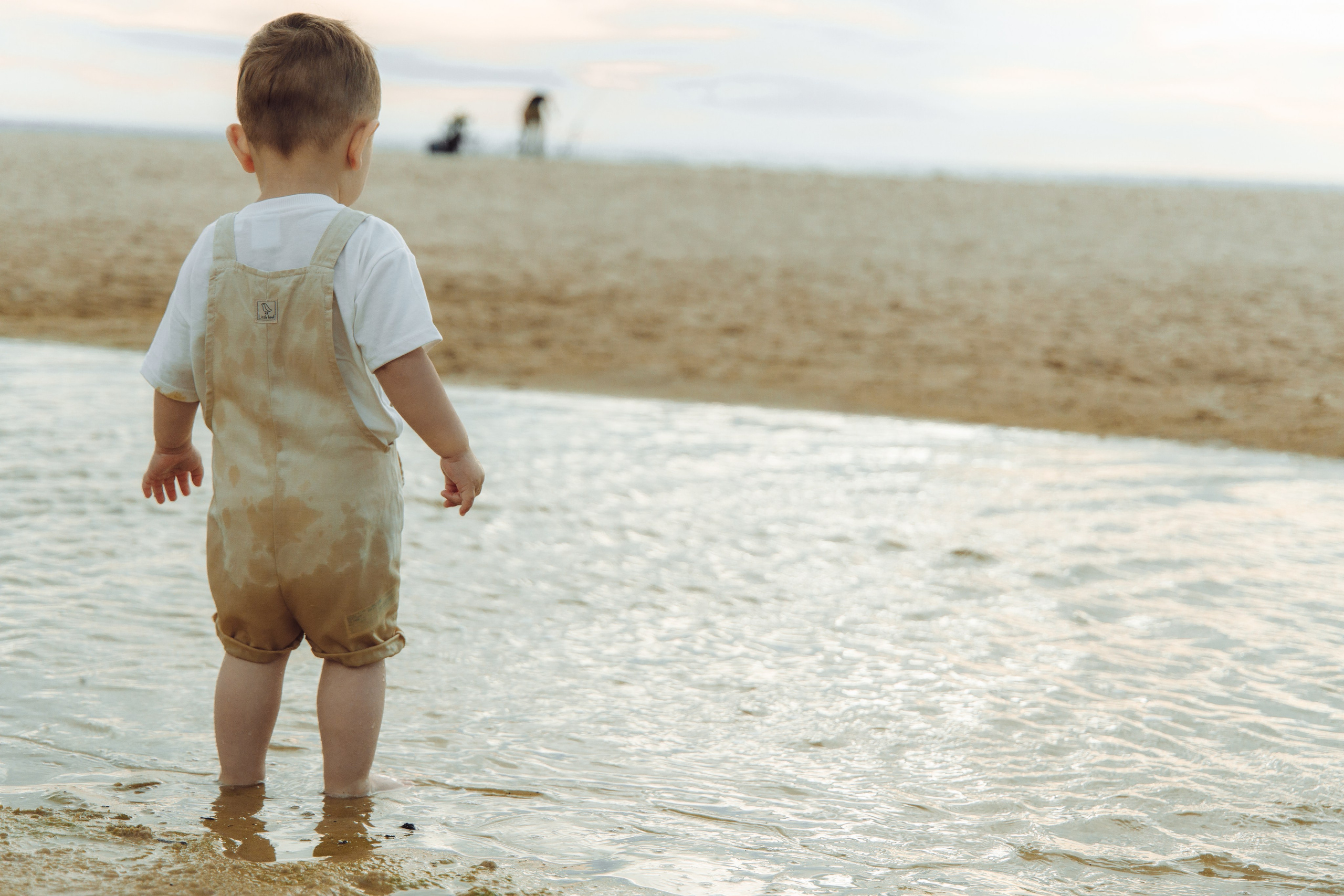 In front of the puddle, child exploring nature