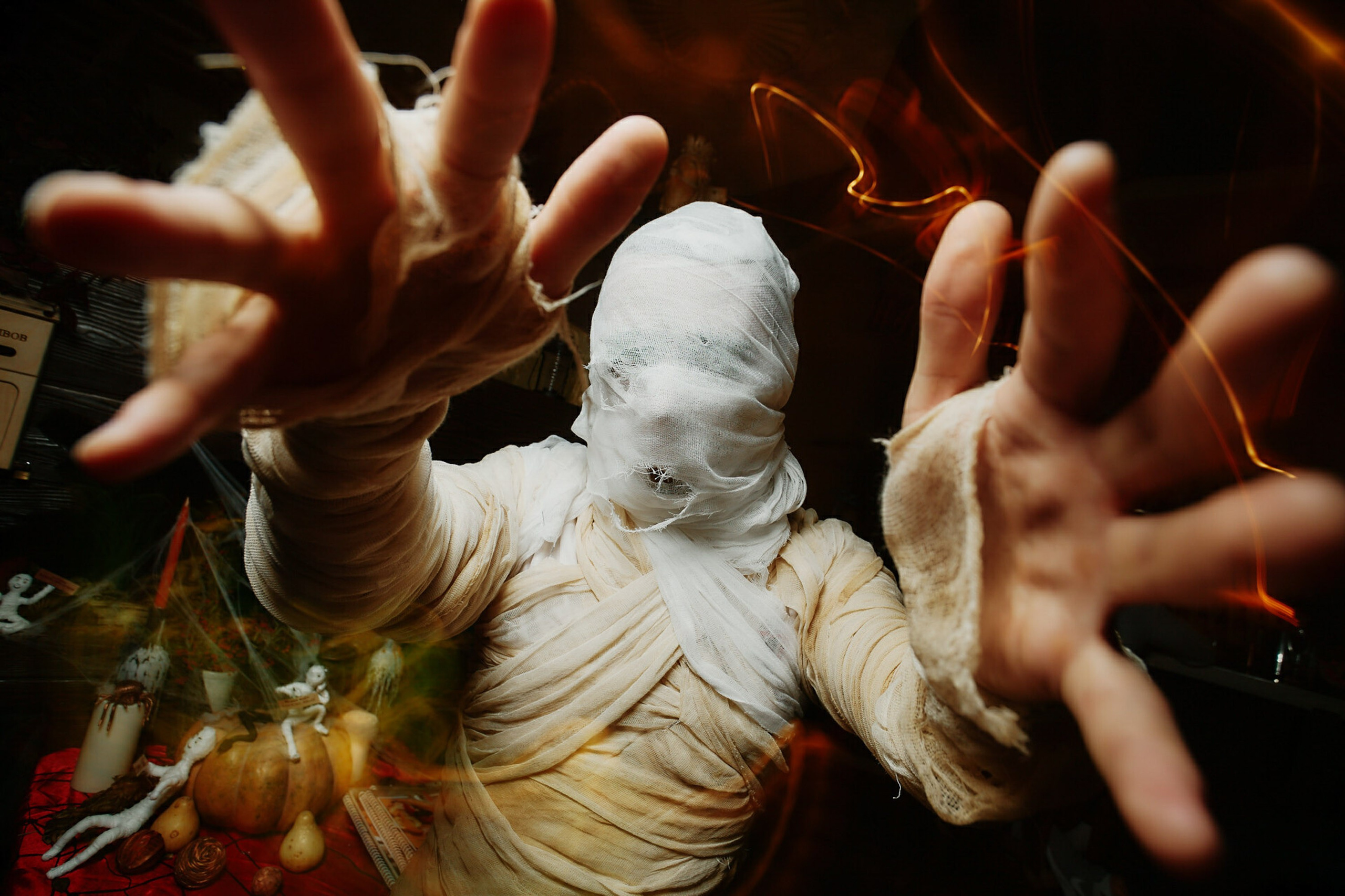 White statue surrounded by hands in dramatic lighting