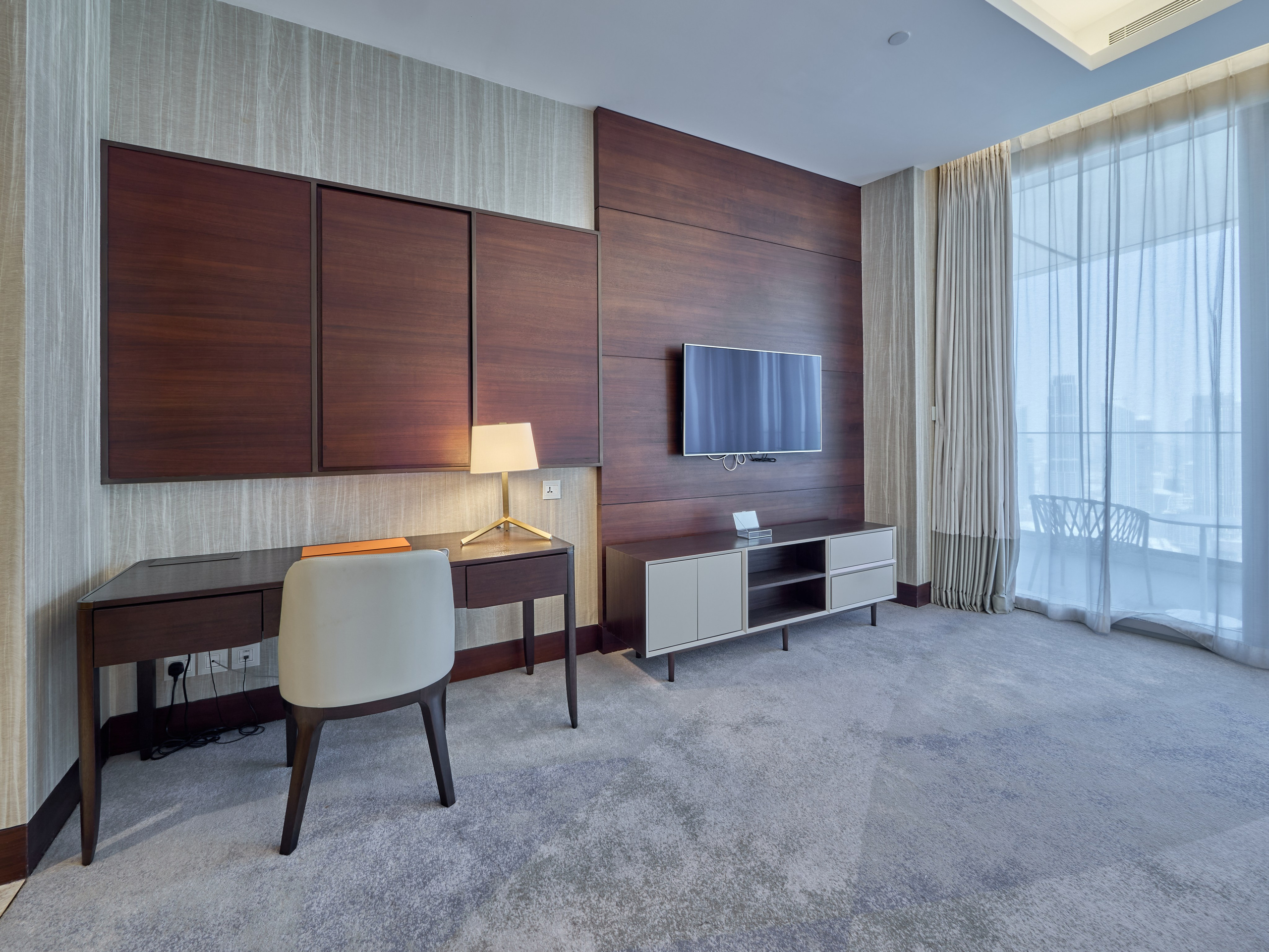 Cozy bedroom with work desk and balcony access