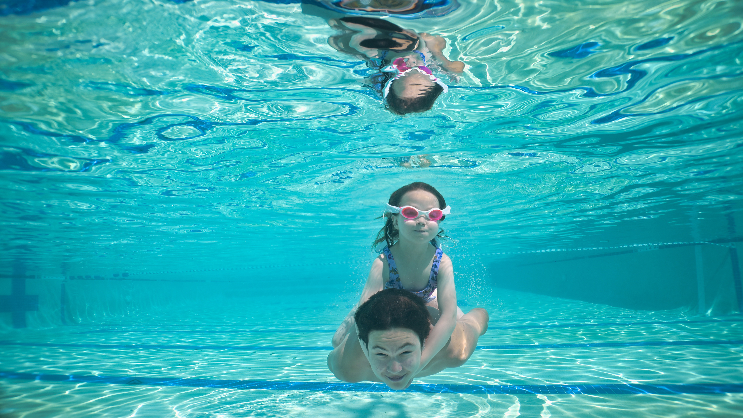 Olga and family underwater. Family and Sports photographer in Cary Raleigh NC North Carolina