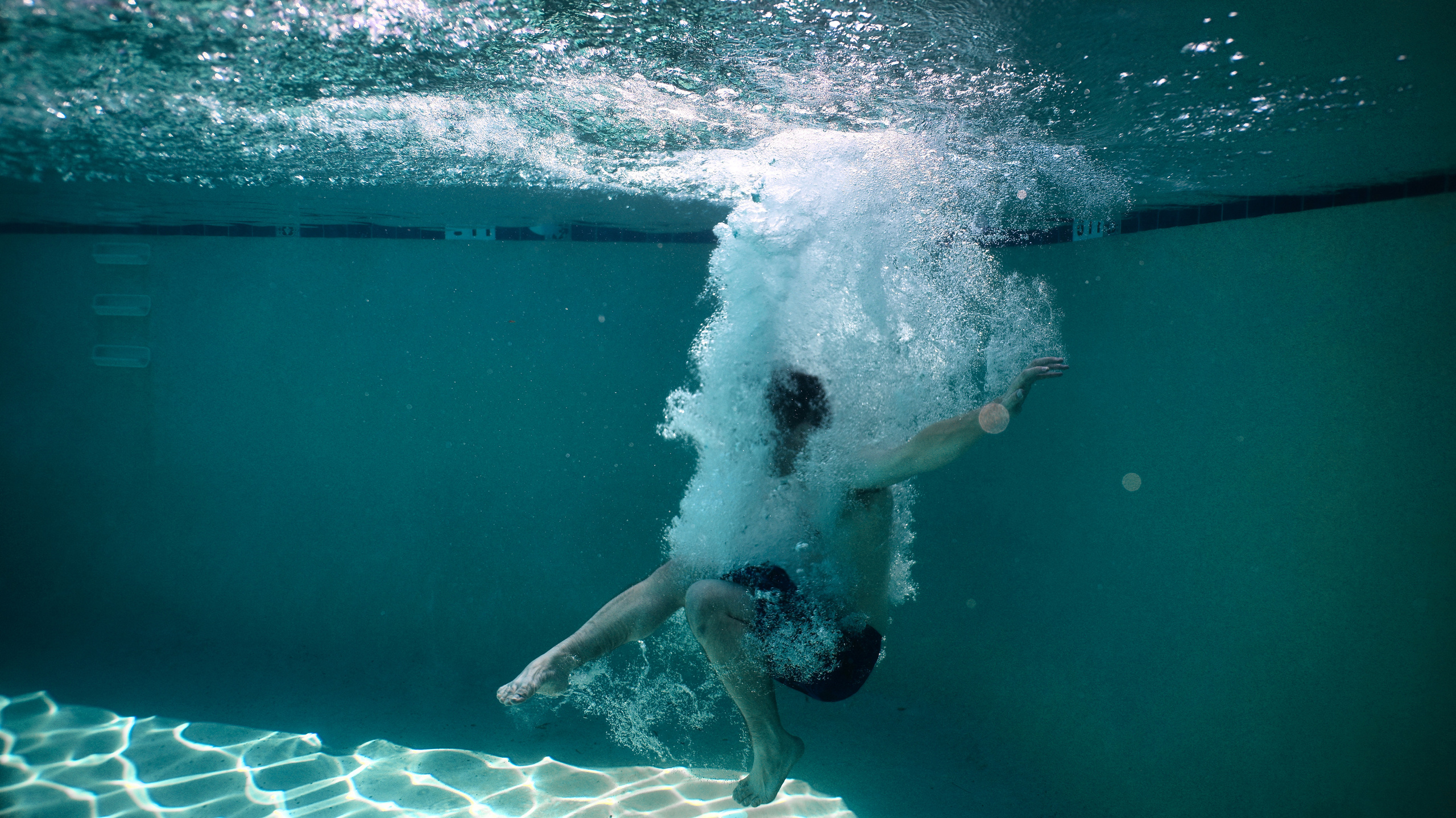 Olga and family underwater. Family and Sports photographer in Cary Raleigh NC North Carolina
