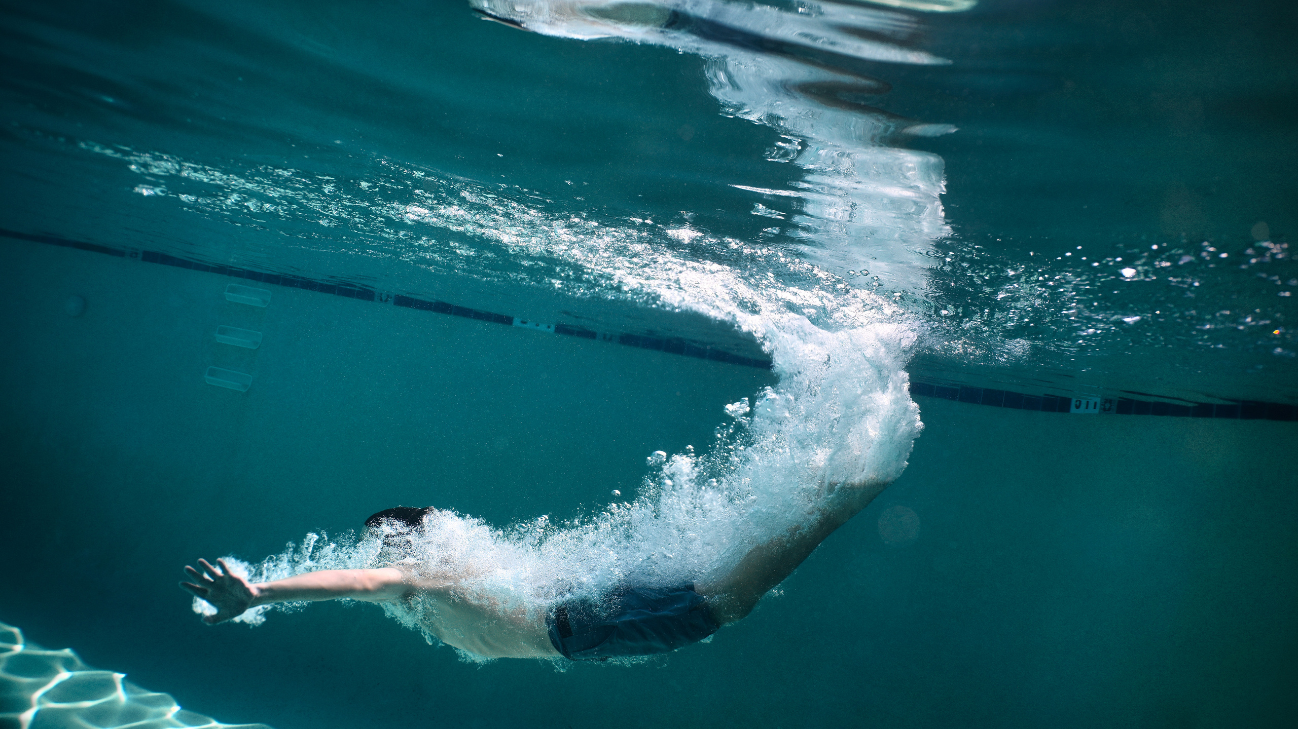 Olga and family underwater. Family and Sports photographer in Cary Raleigh NC North Carolina