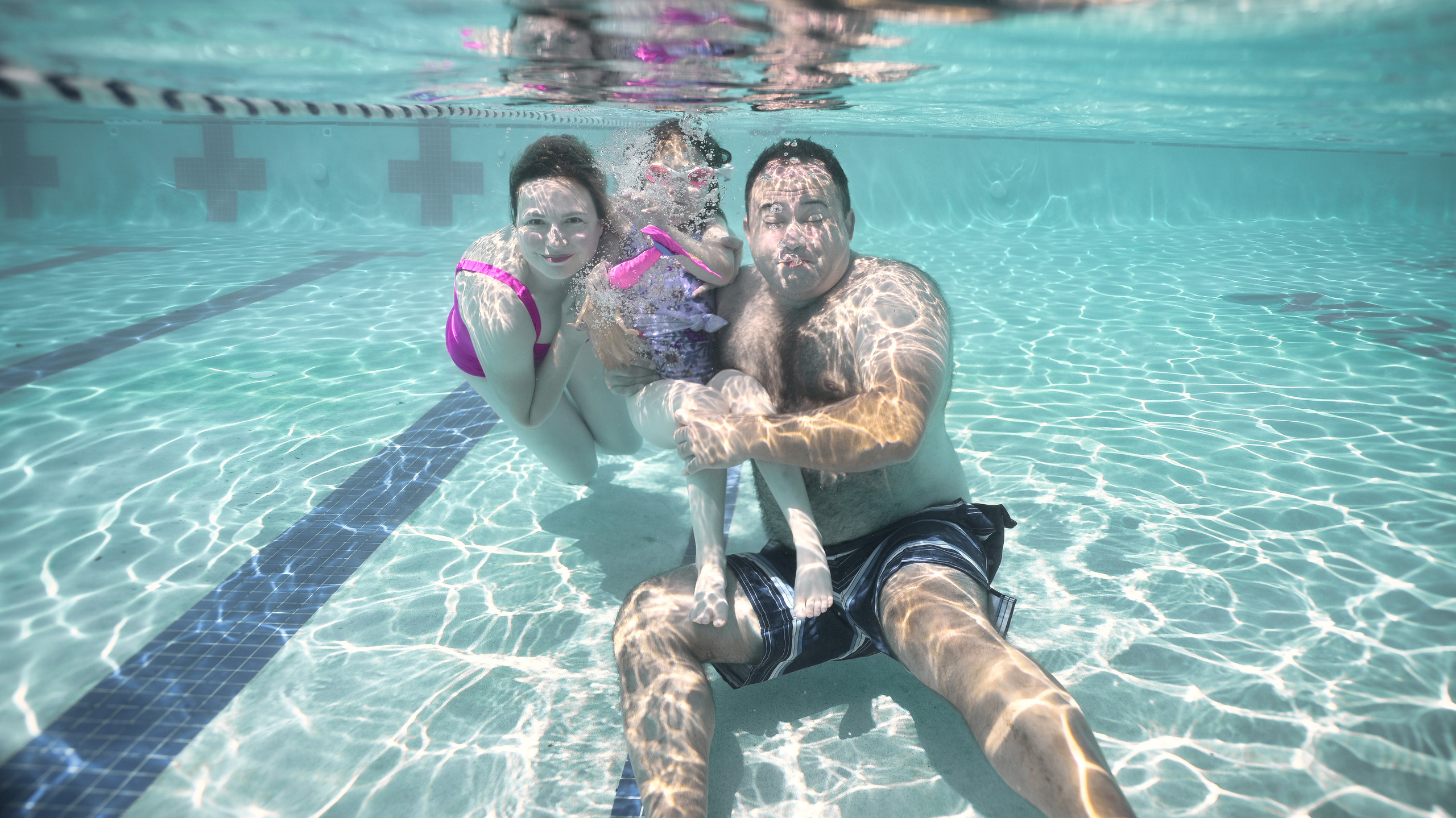 Olga and family underwater. Family and Sports photographer in Cary Raleigh NC North Carolina
