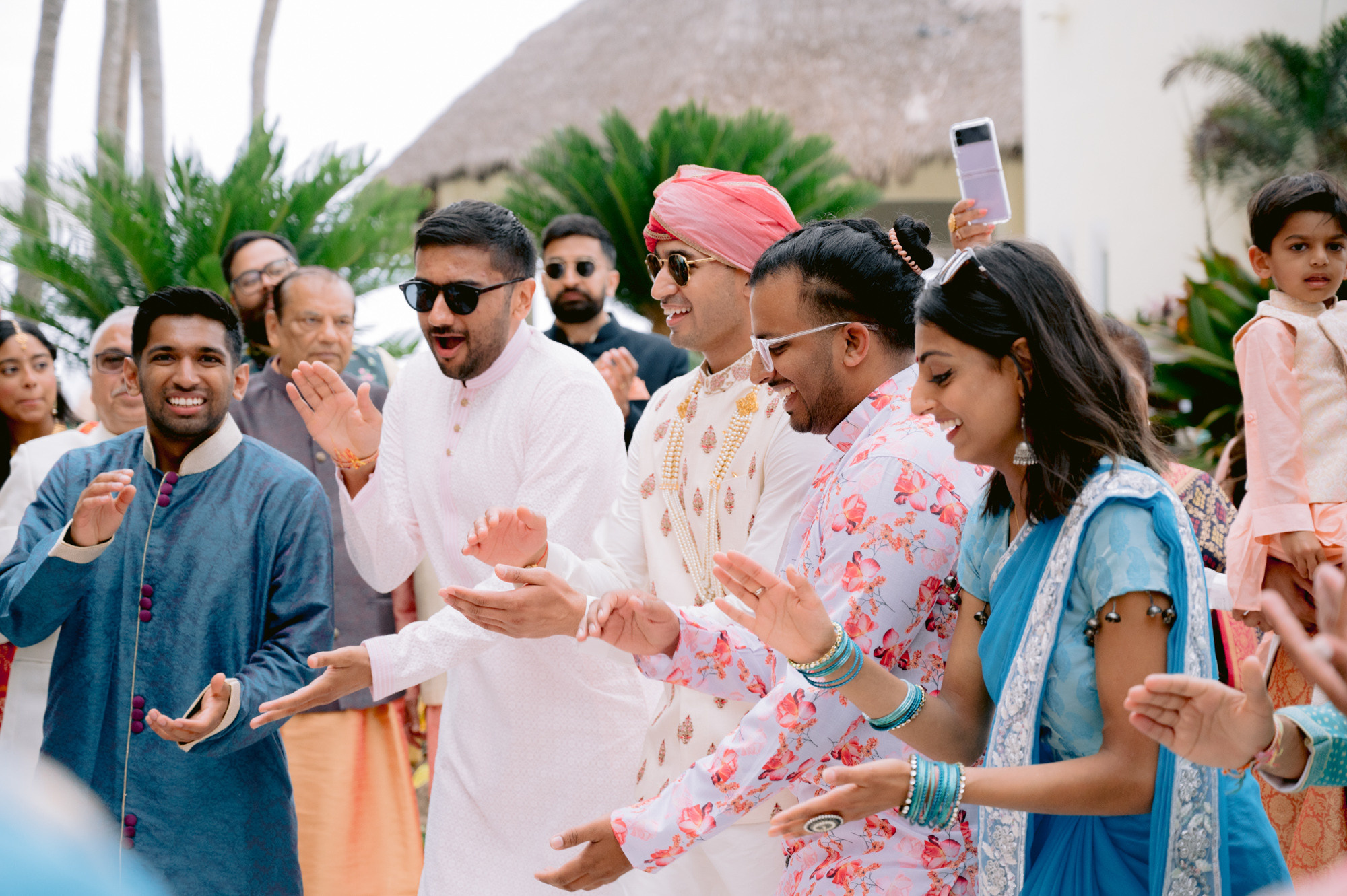 a group of people standing around a man in a white shirt