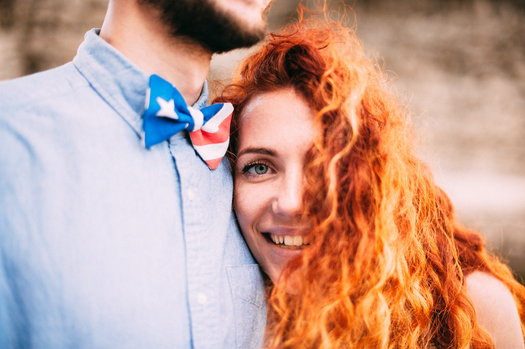 a man and woman with red hair and blue shirts