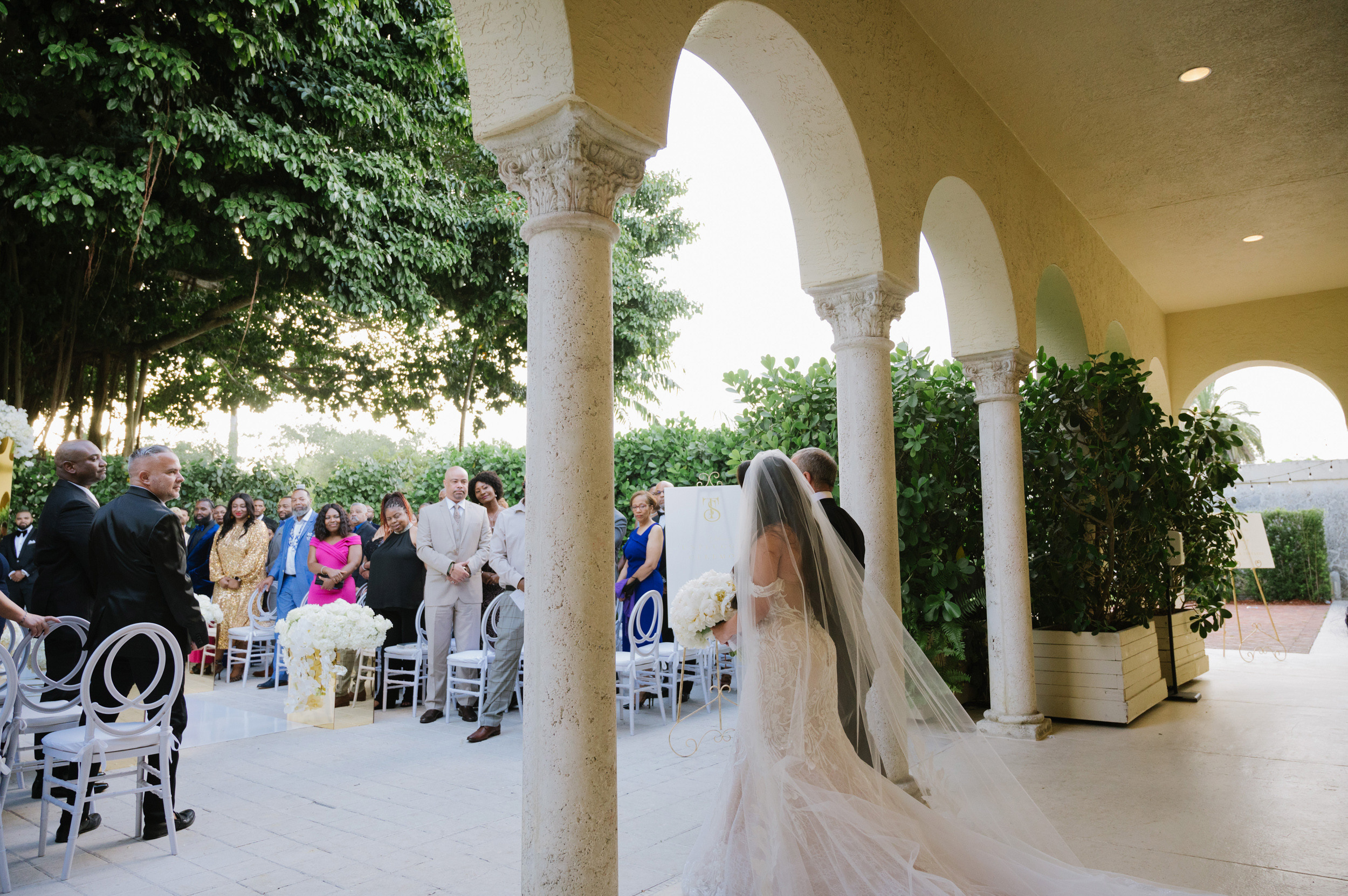 a bride walking down the aisle of a wedding ceremony