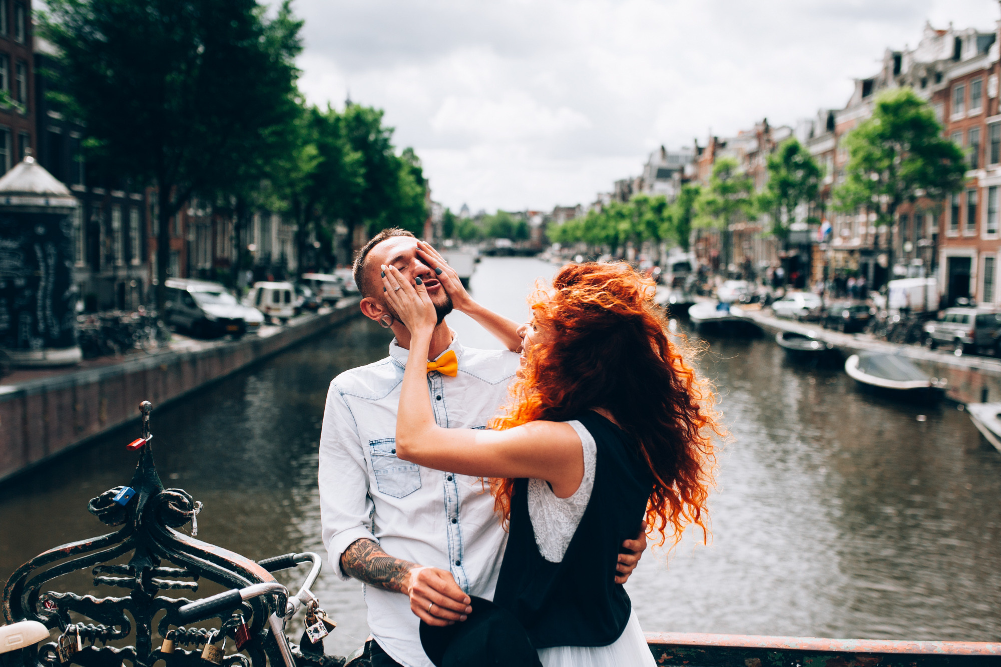a man and woman standing on a bridge