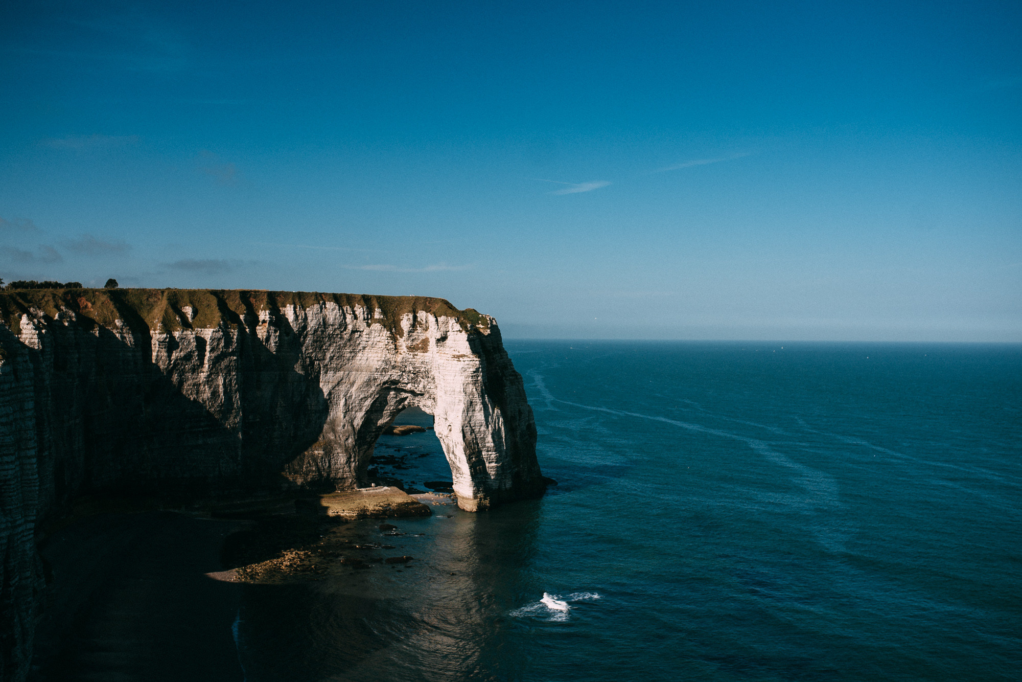 a cliff with a large body of water