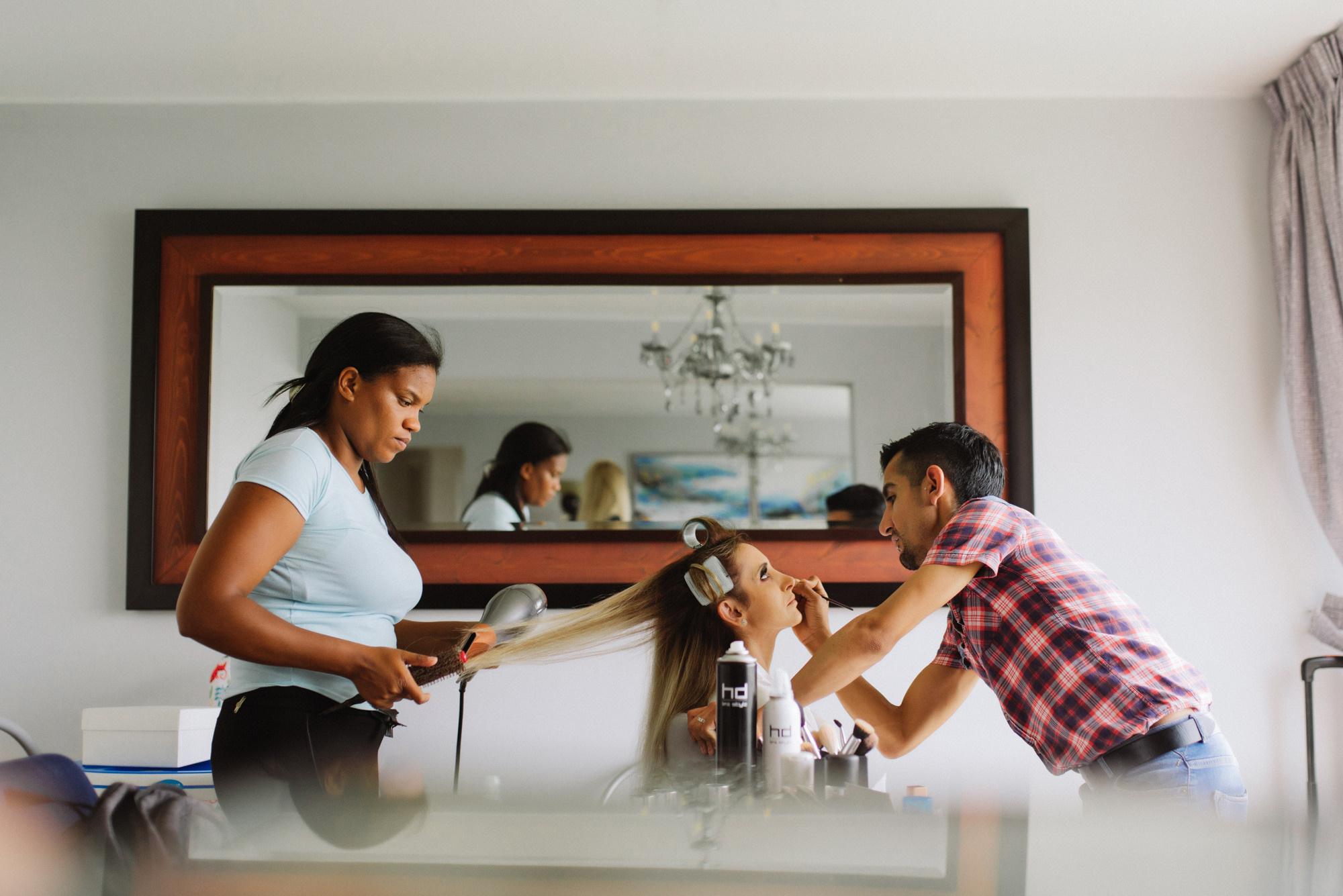 a woman is getting her hair done