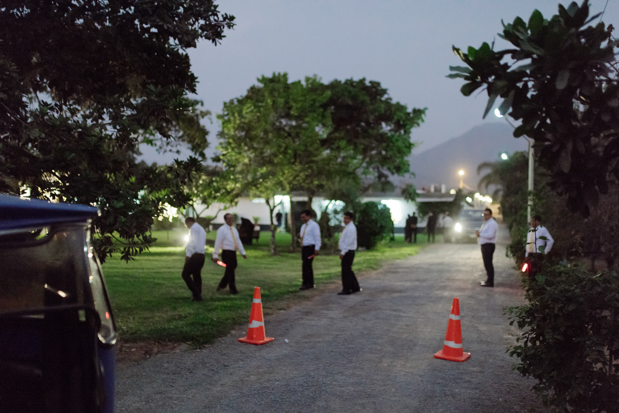 a group of people standing around a road