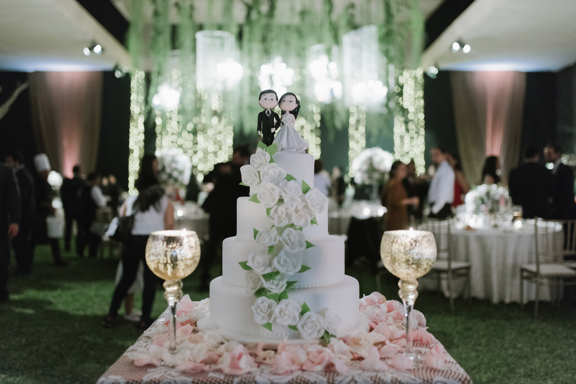 a wedding cake with a bride and groom on top