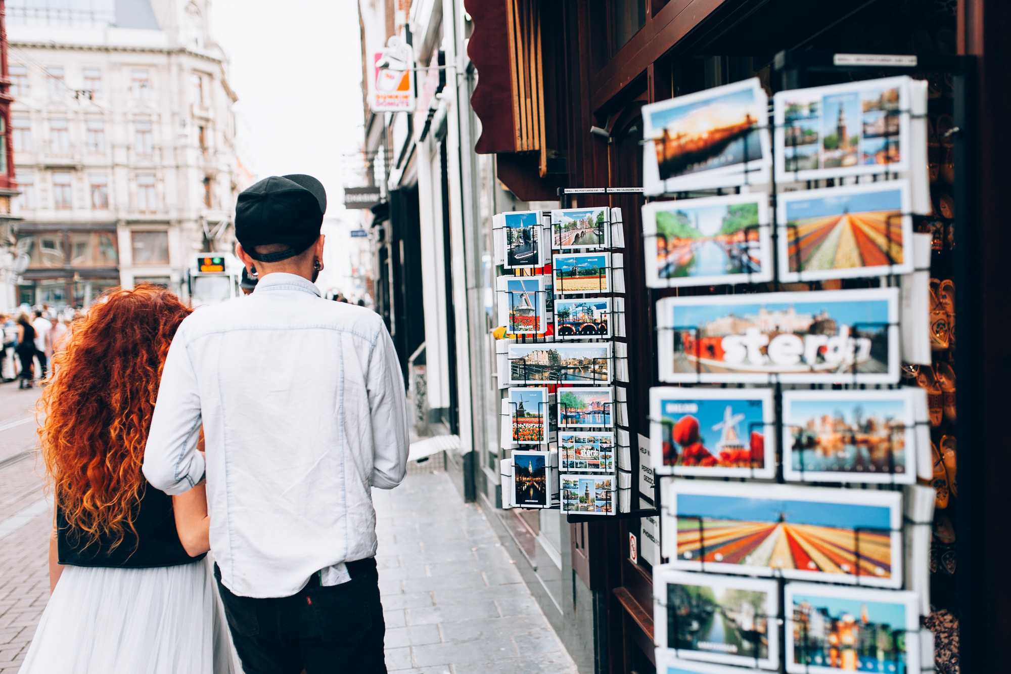 a couple walking down a street in a city