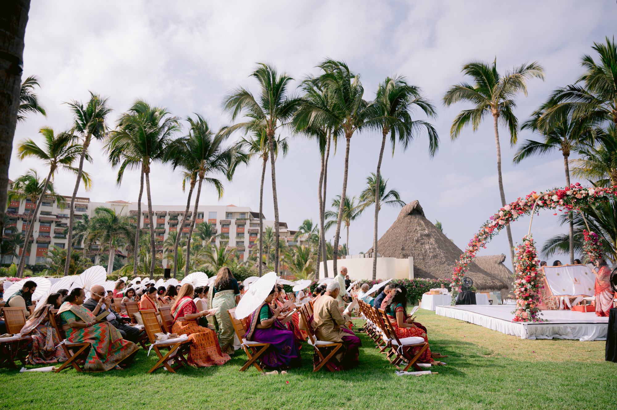 a group of people sitting on a lawn