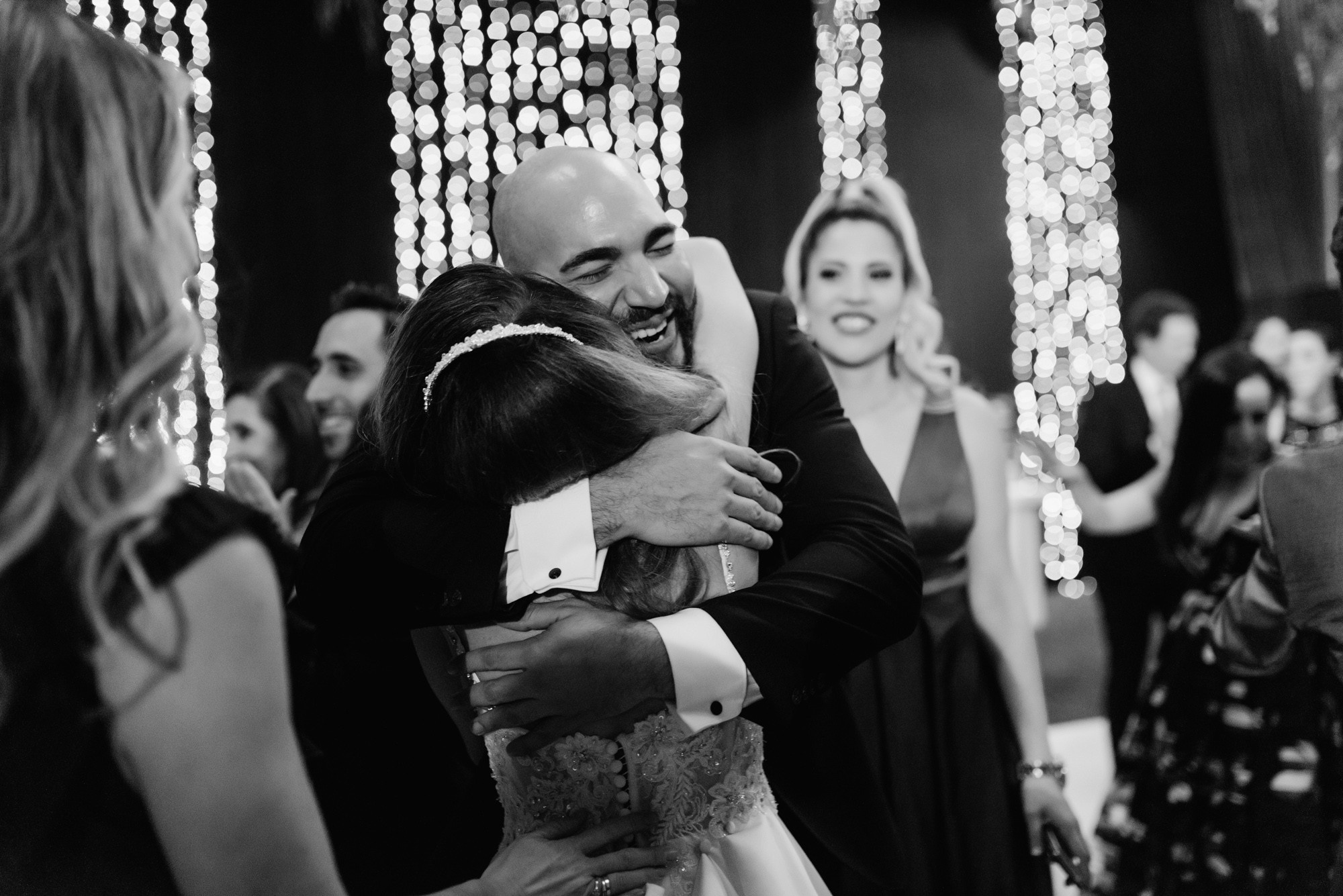 a bride hugging her groom at the wedding reception
