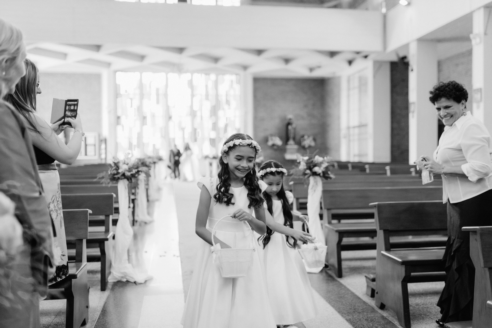 a little girl is walking down the aisle