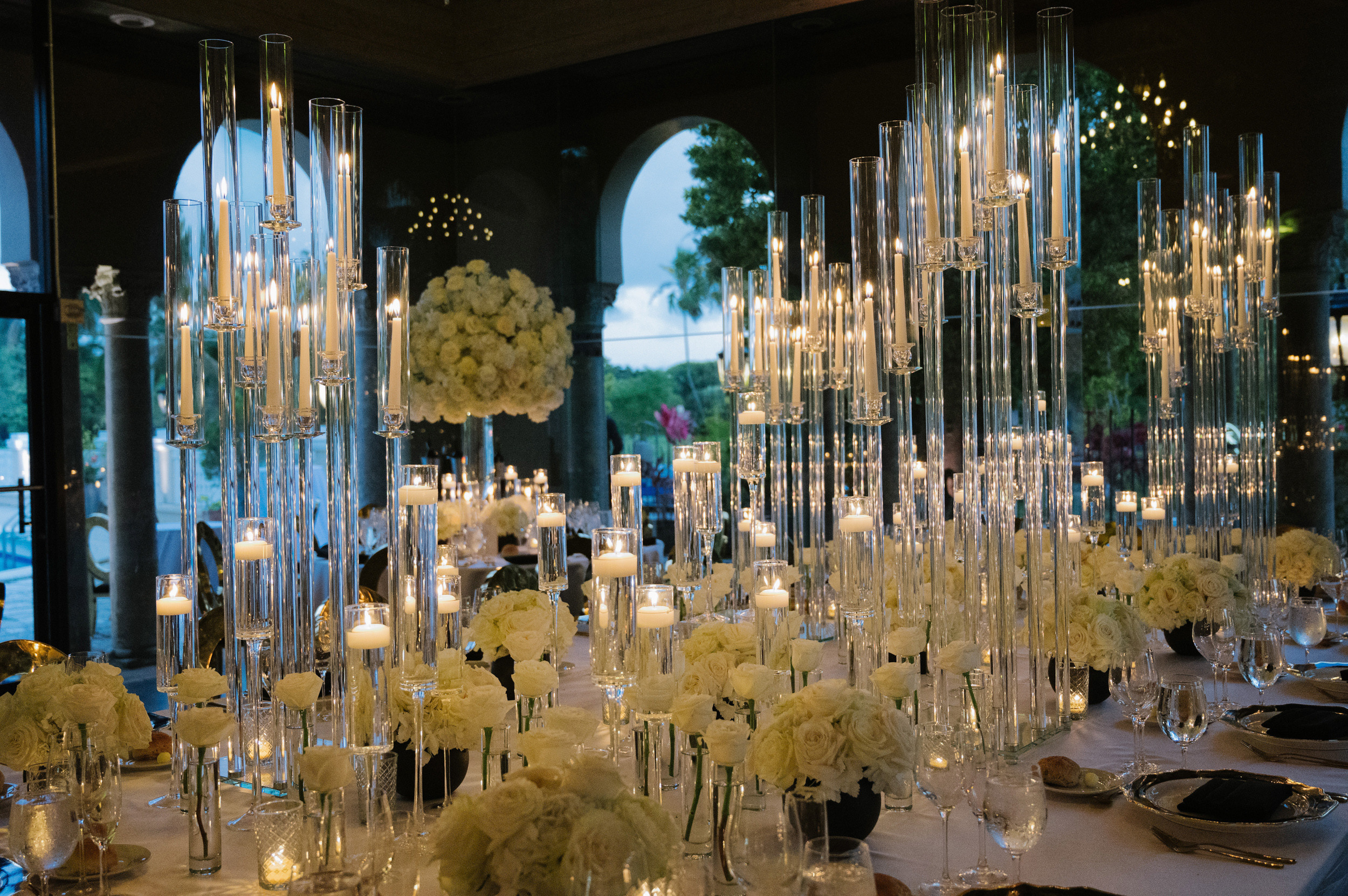 a table with a bunch of flowers and candles