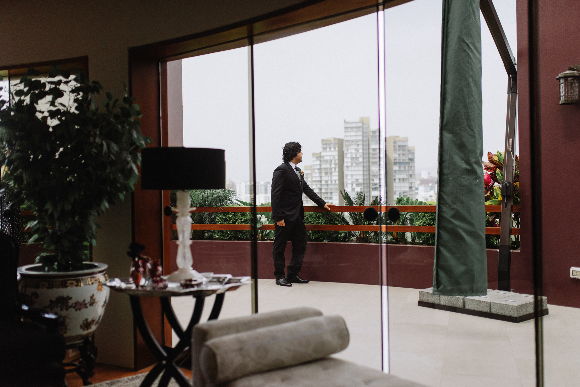 a man in a suit standing in a living room