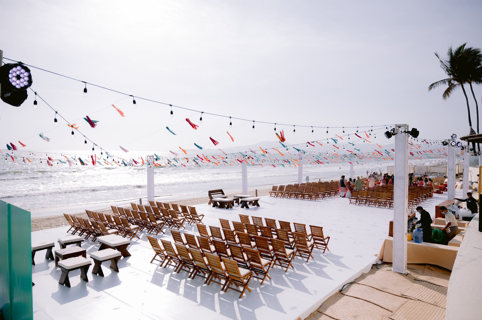 a beach with a lot of chairs and a lot of flags