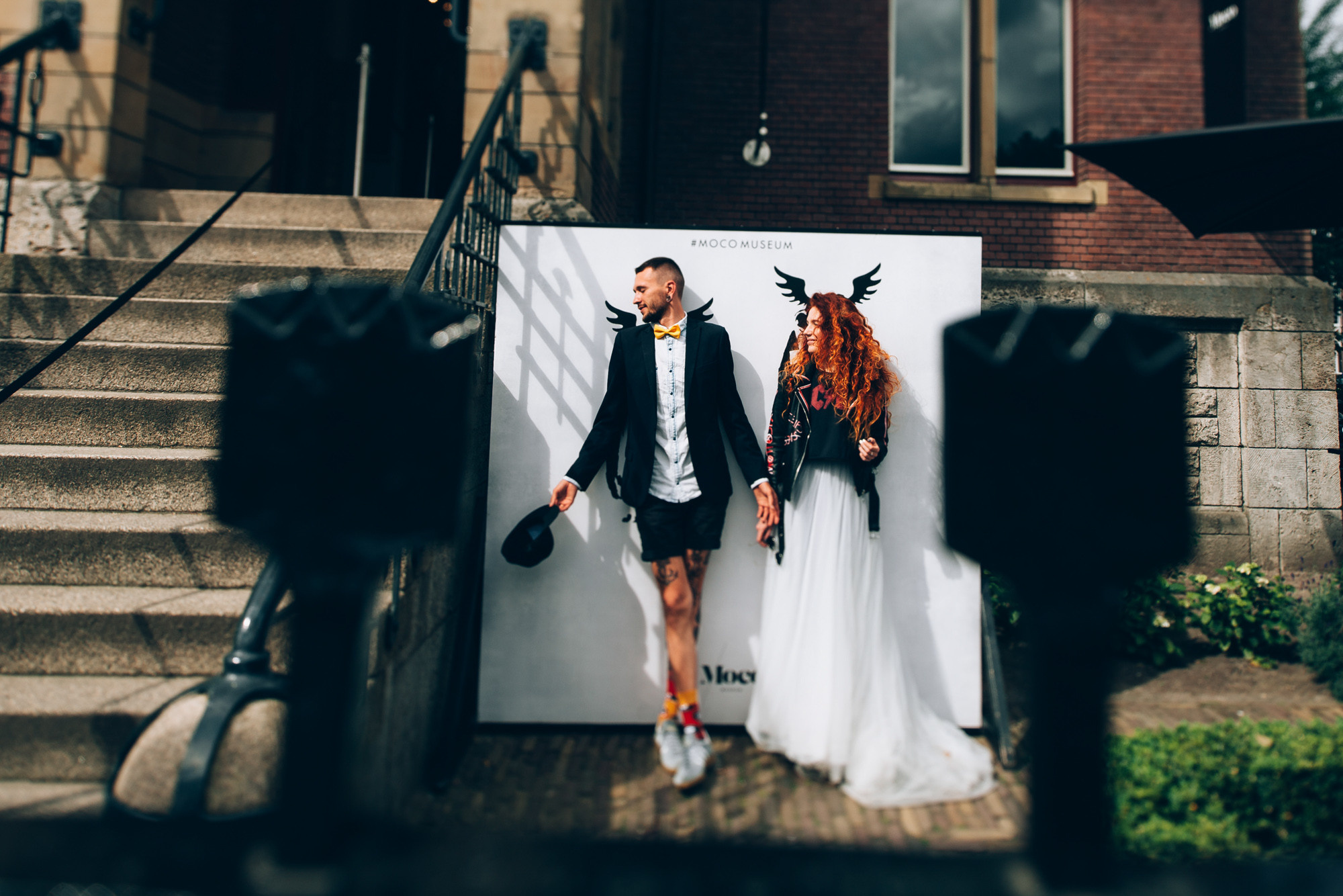 a couple is posing for a picture on a wall