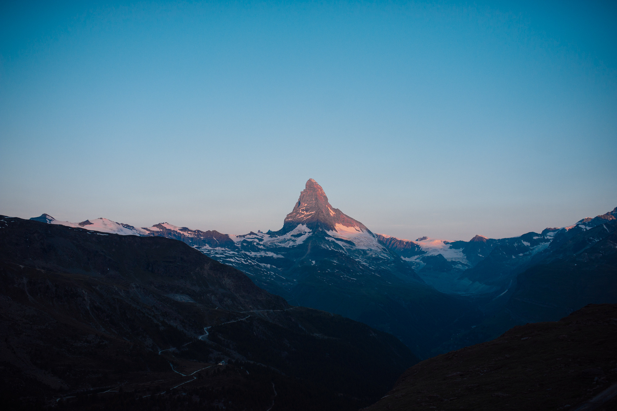 a mountain range with a mountain peak in the distance