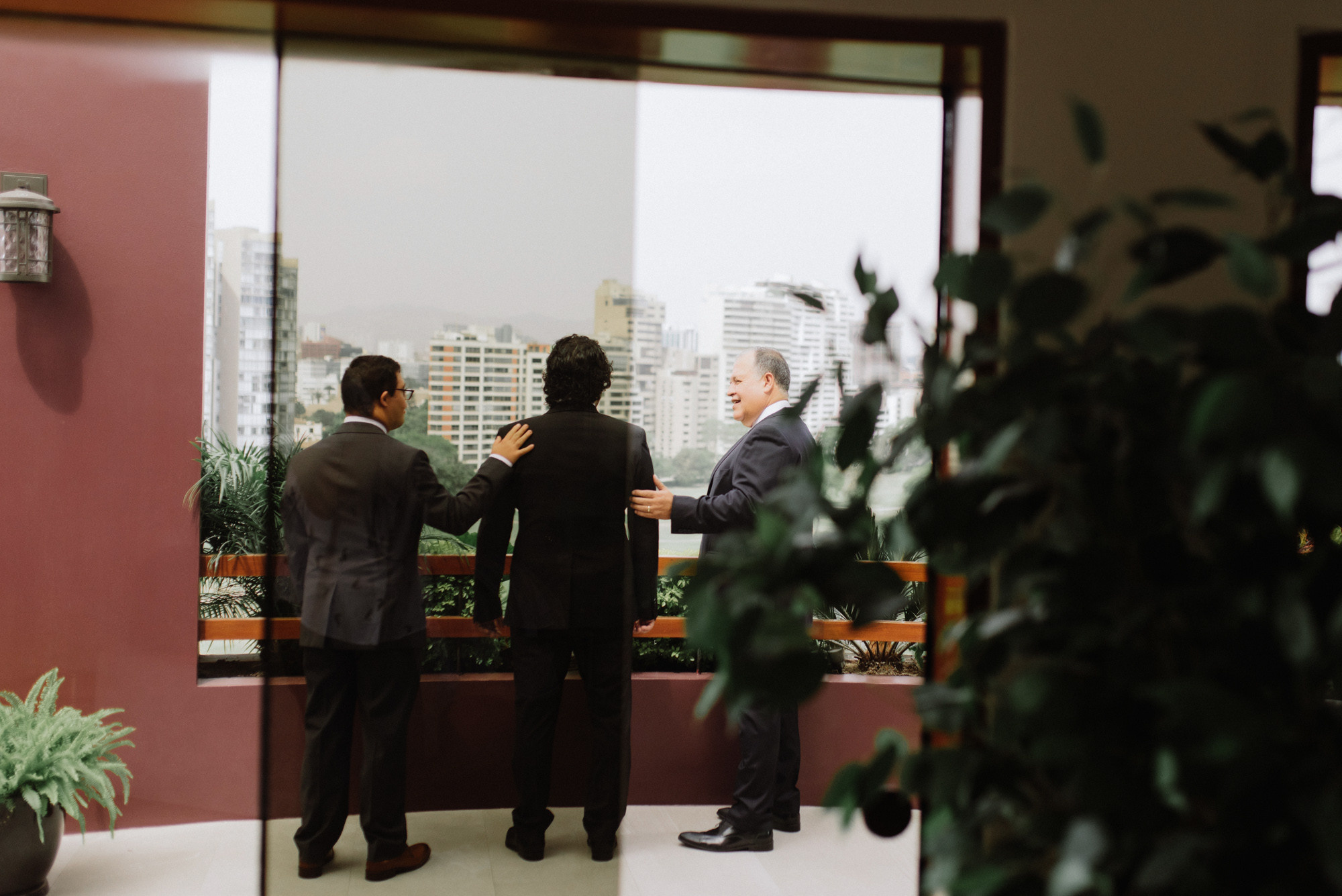 two men in suits are standing in a room