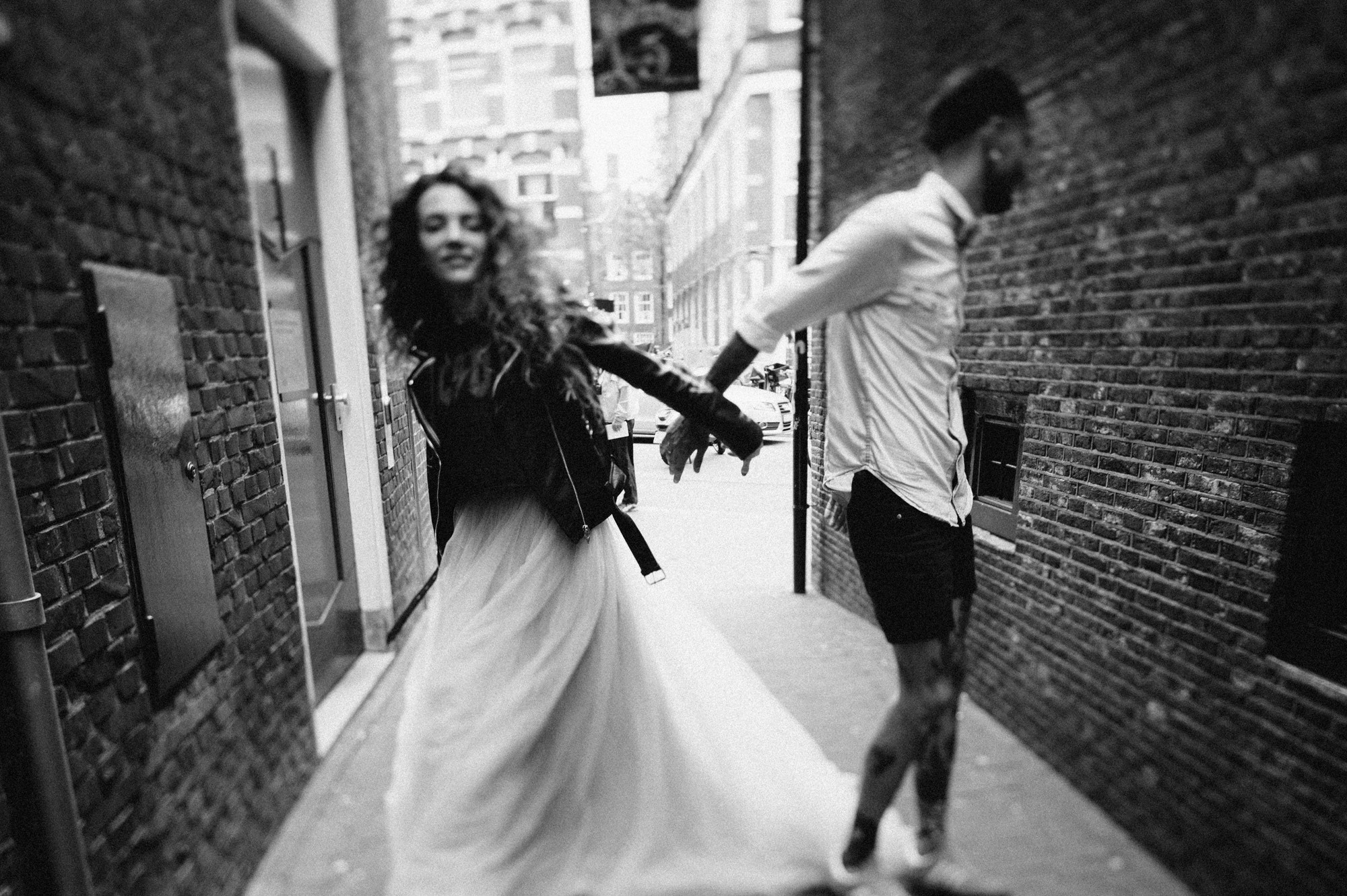 a couple walking down a street holding hands