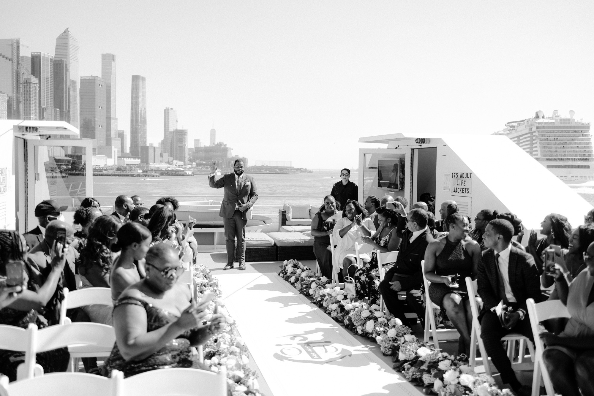a man standing on a rooftop with a crowd of people